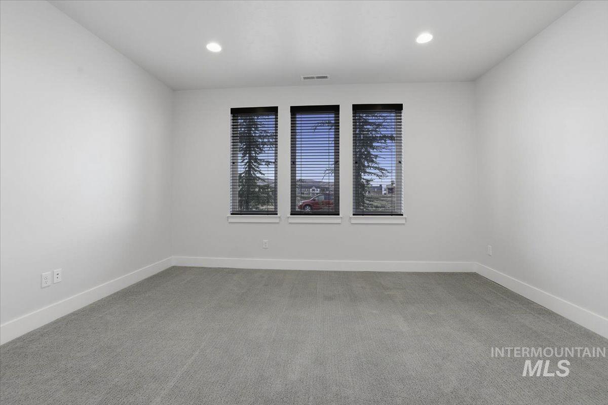 Unfurnished room featuring light colored carpet and recessed lighting