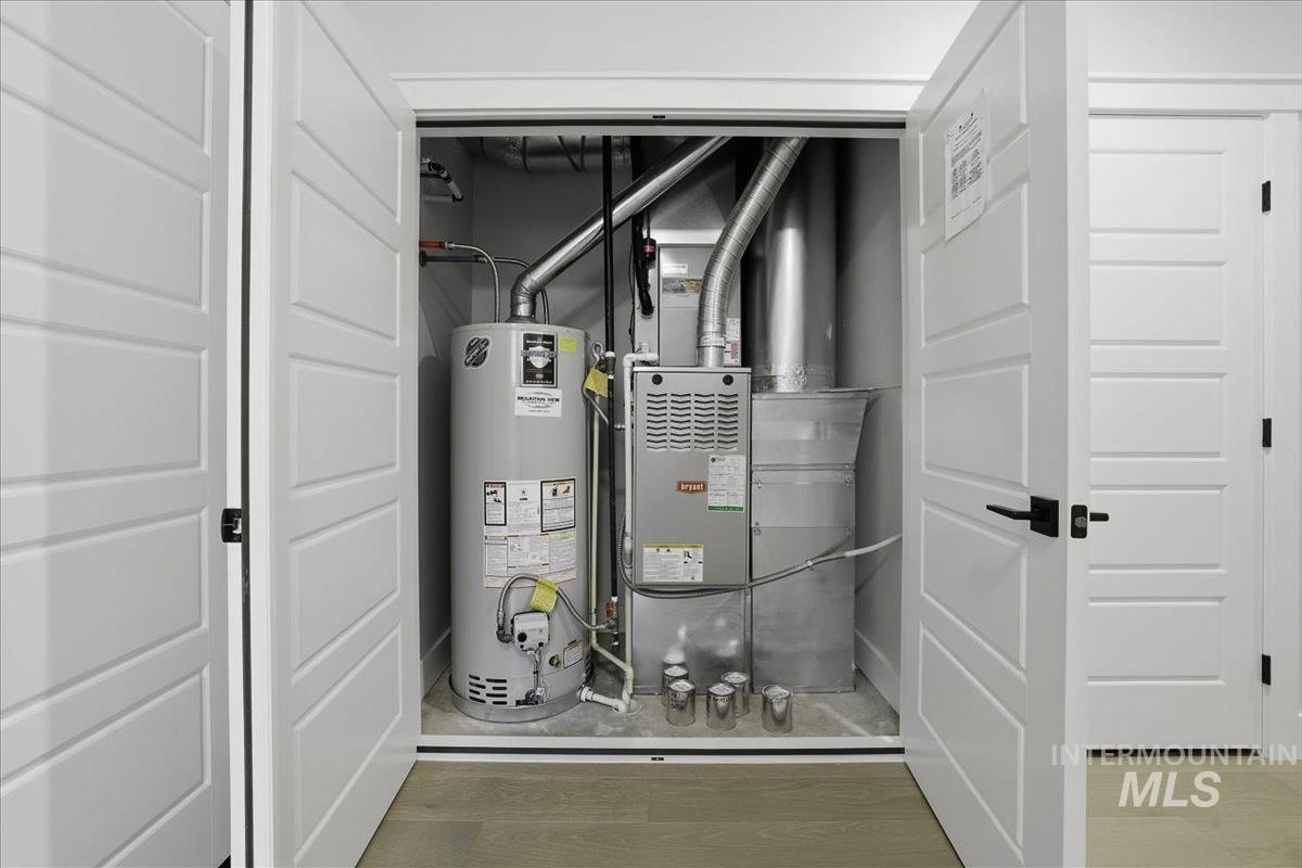 Utility room with gas water heater and heating unit