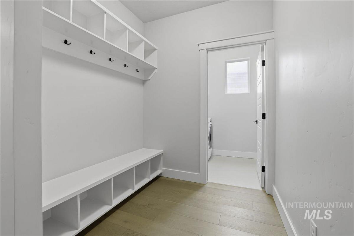 Mudroom featuring light wood finished floors and washer / dryer