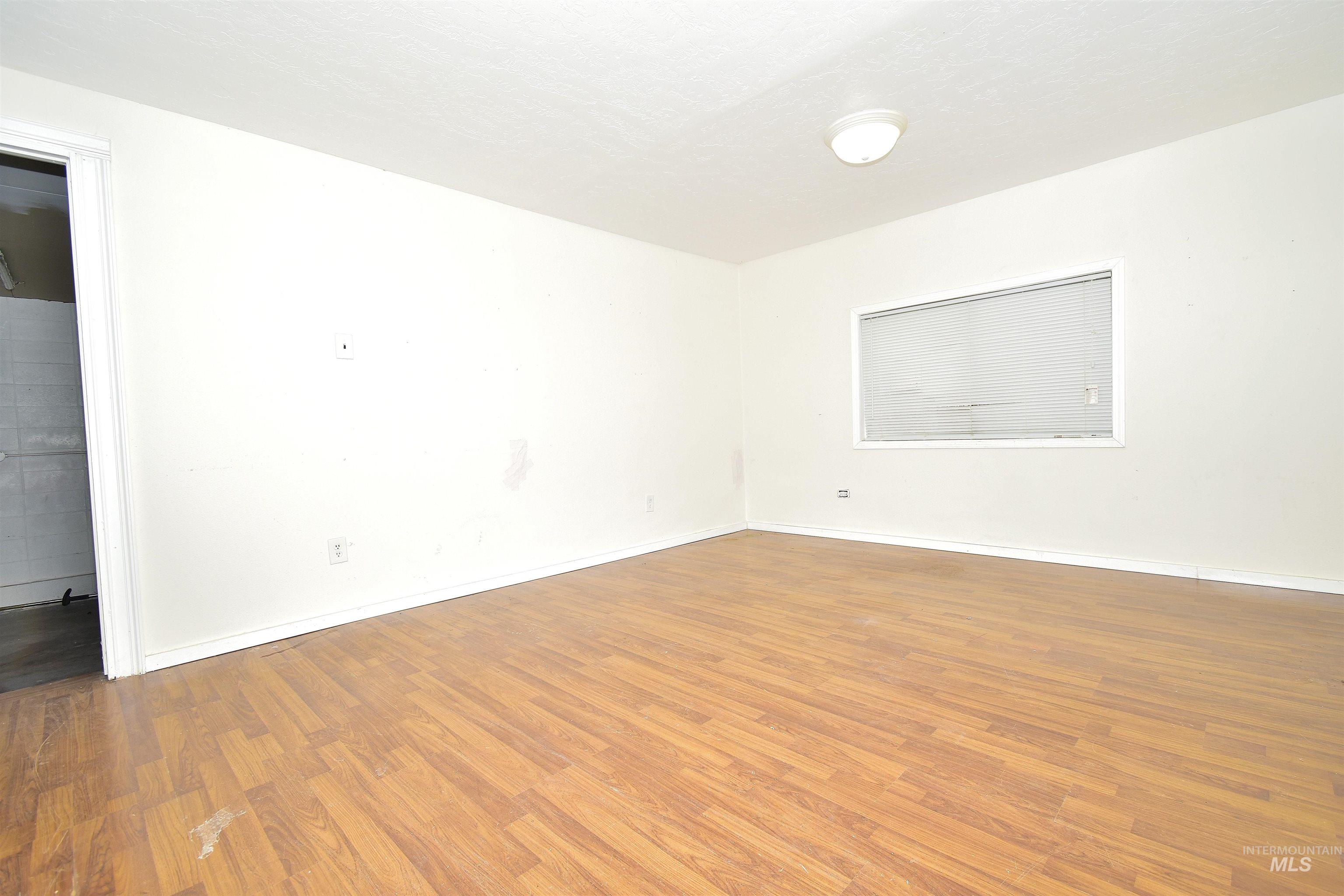 Empty room featuring wood finished floors