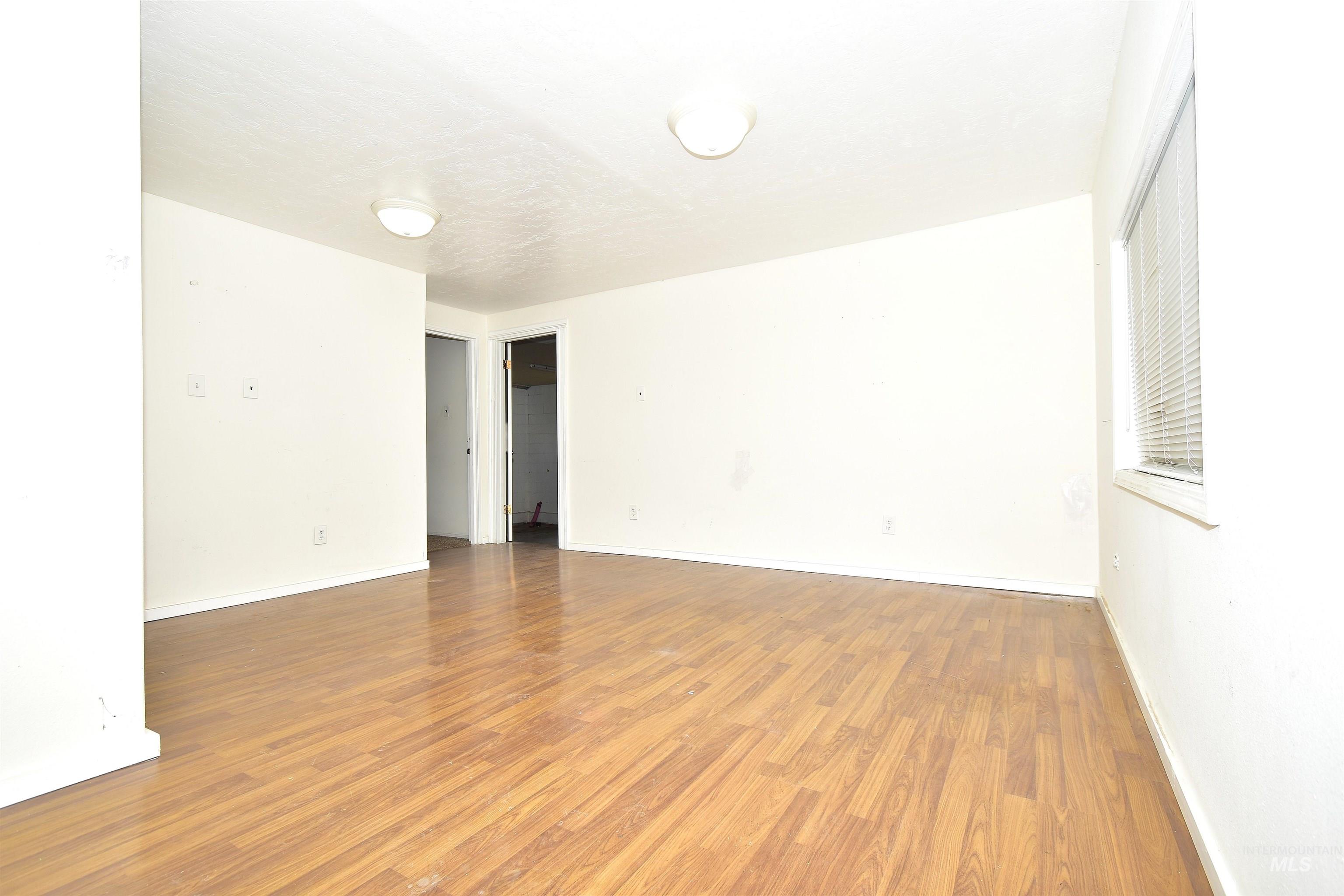 Spare room with light wood-style floors and baseboards