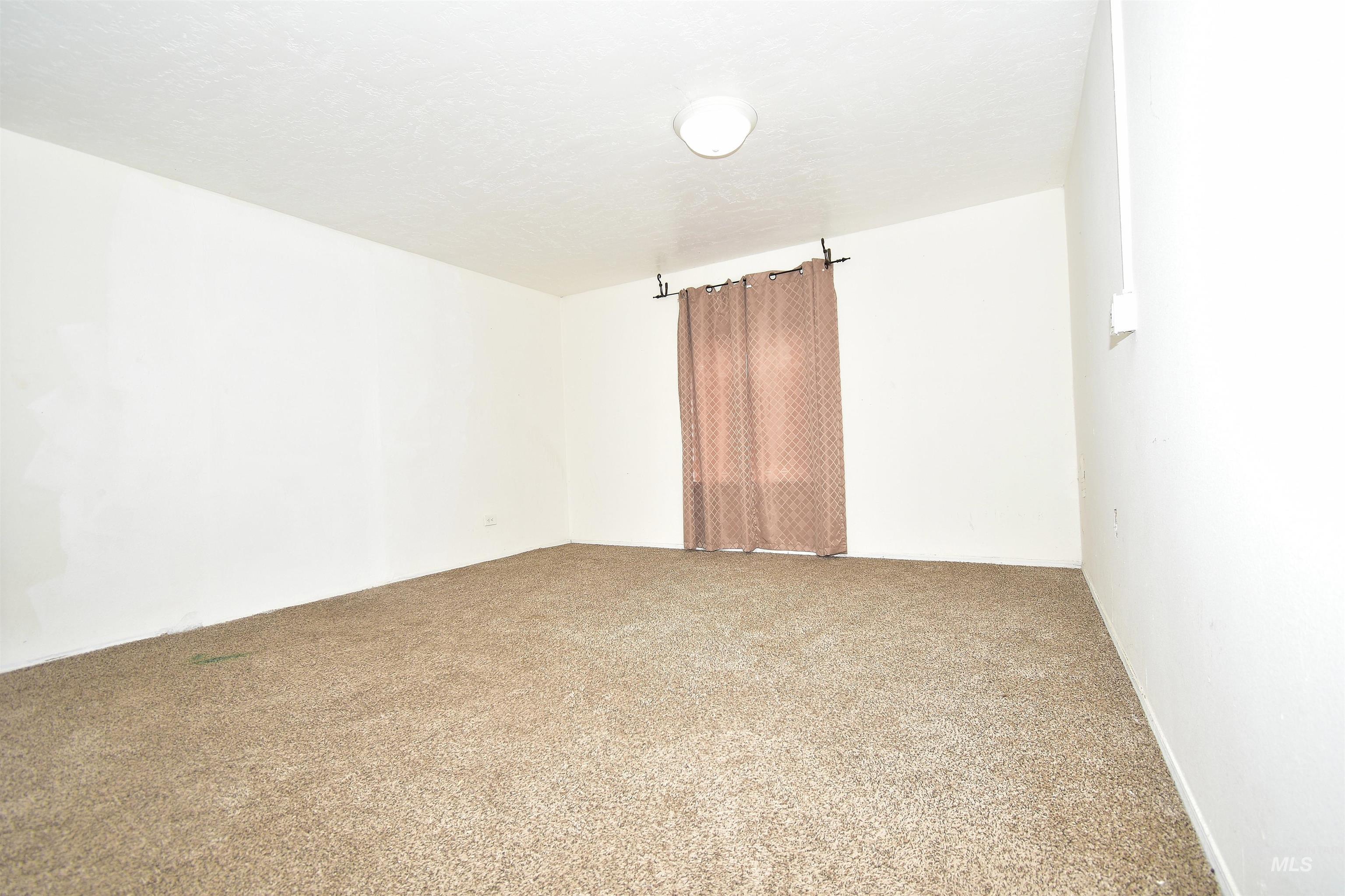 Unfurnished room with carpet