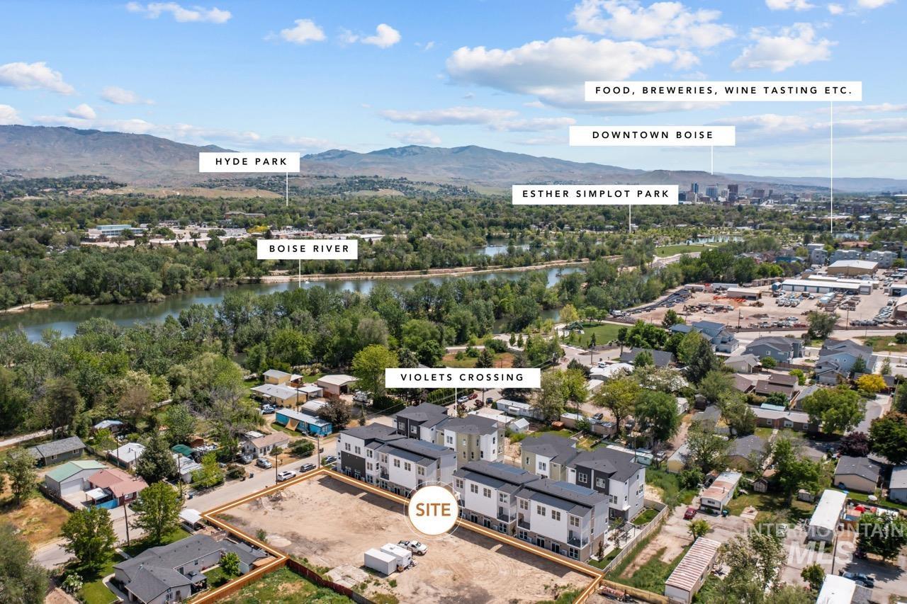 Aerial view of property and surrounding area featuring a water and mountain view and nearby suburban area