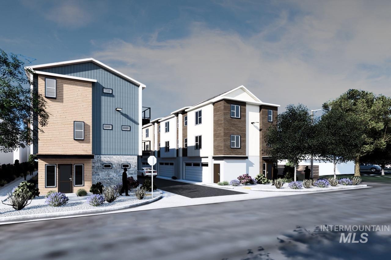View of property with a garage and asphalt driveway