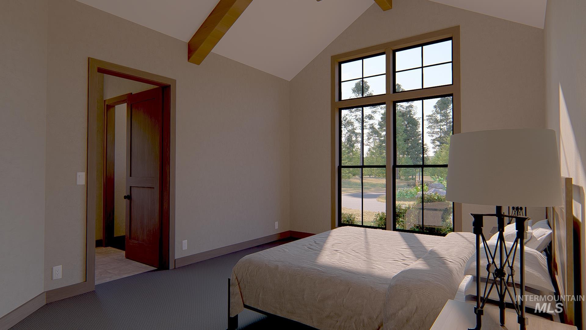 Carpeted bedroom with beam ceiling and high vaulted ceiling