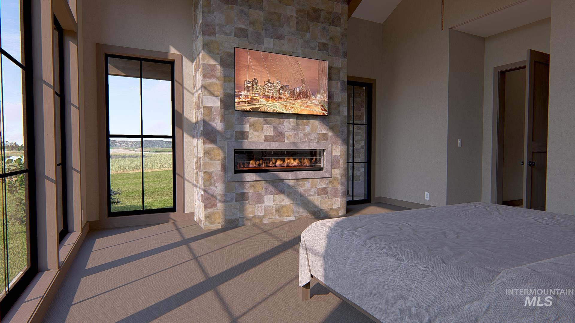 Bedroom featuring a stone fireplace