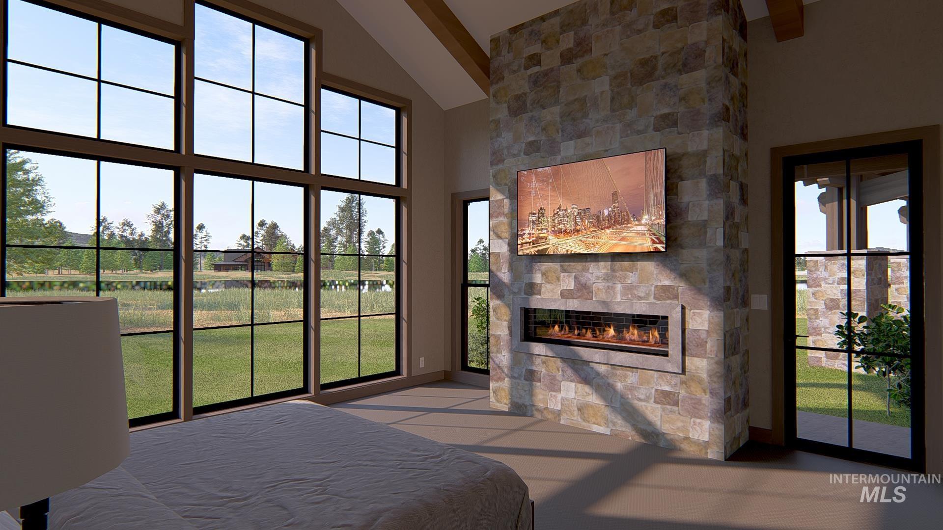 Bedroom with access to exterior, a fireplace, and high vaulted ceiling