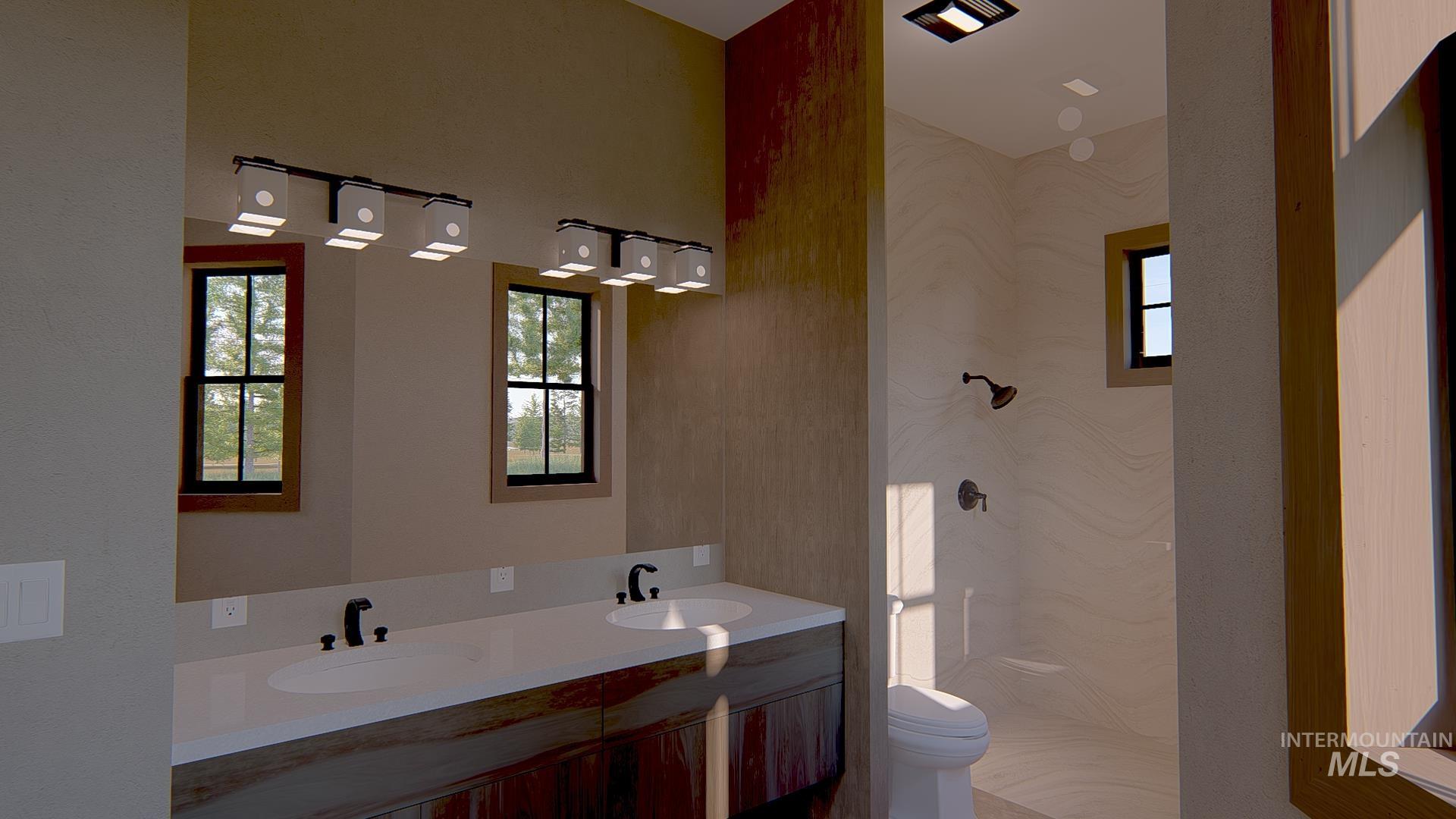 Bathroom featuring double vanity and a marble finish shower