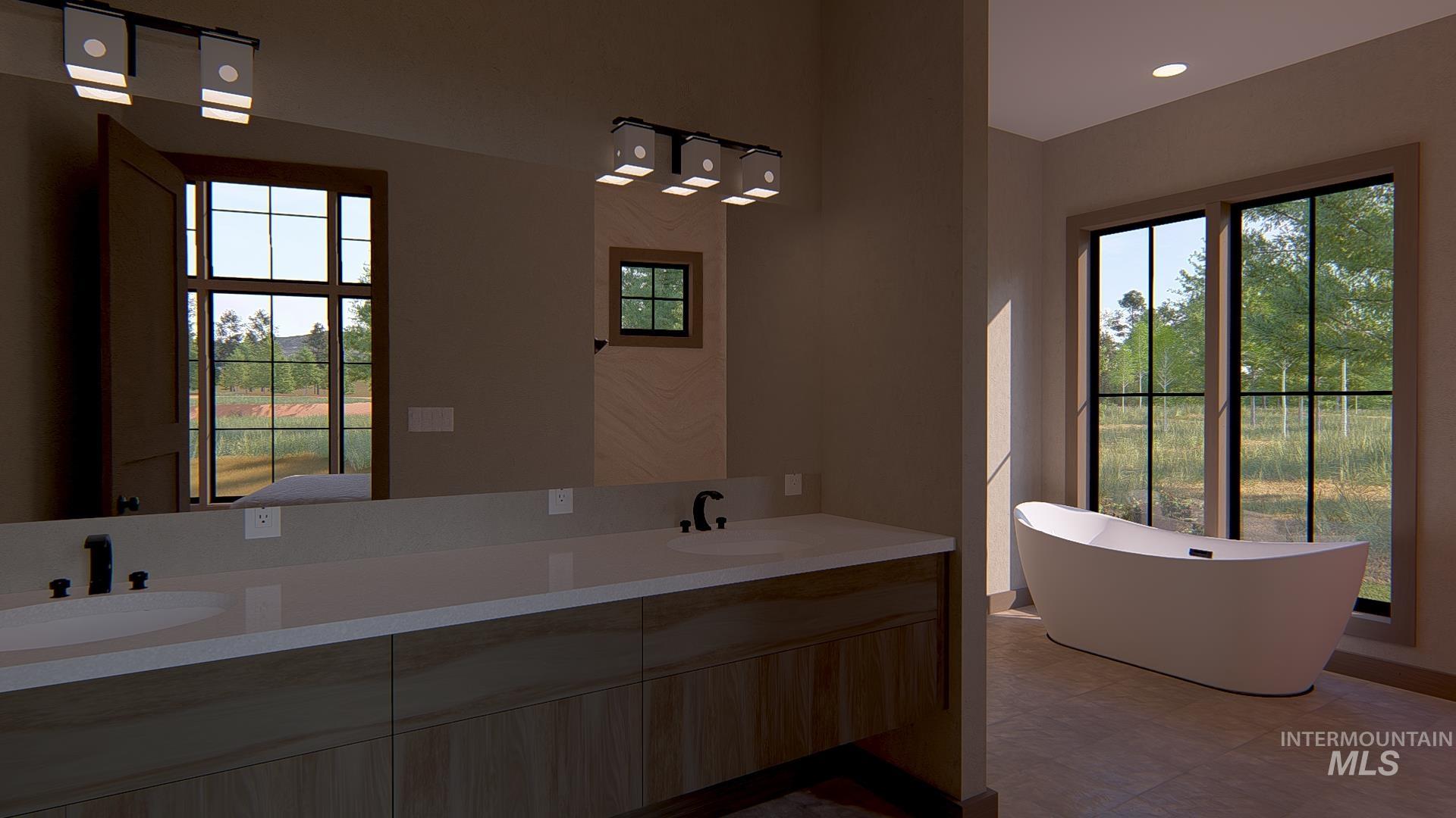 Bathroom featuring a freestanding tub, double vanity, and recessed lighting