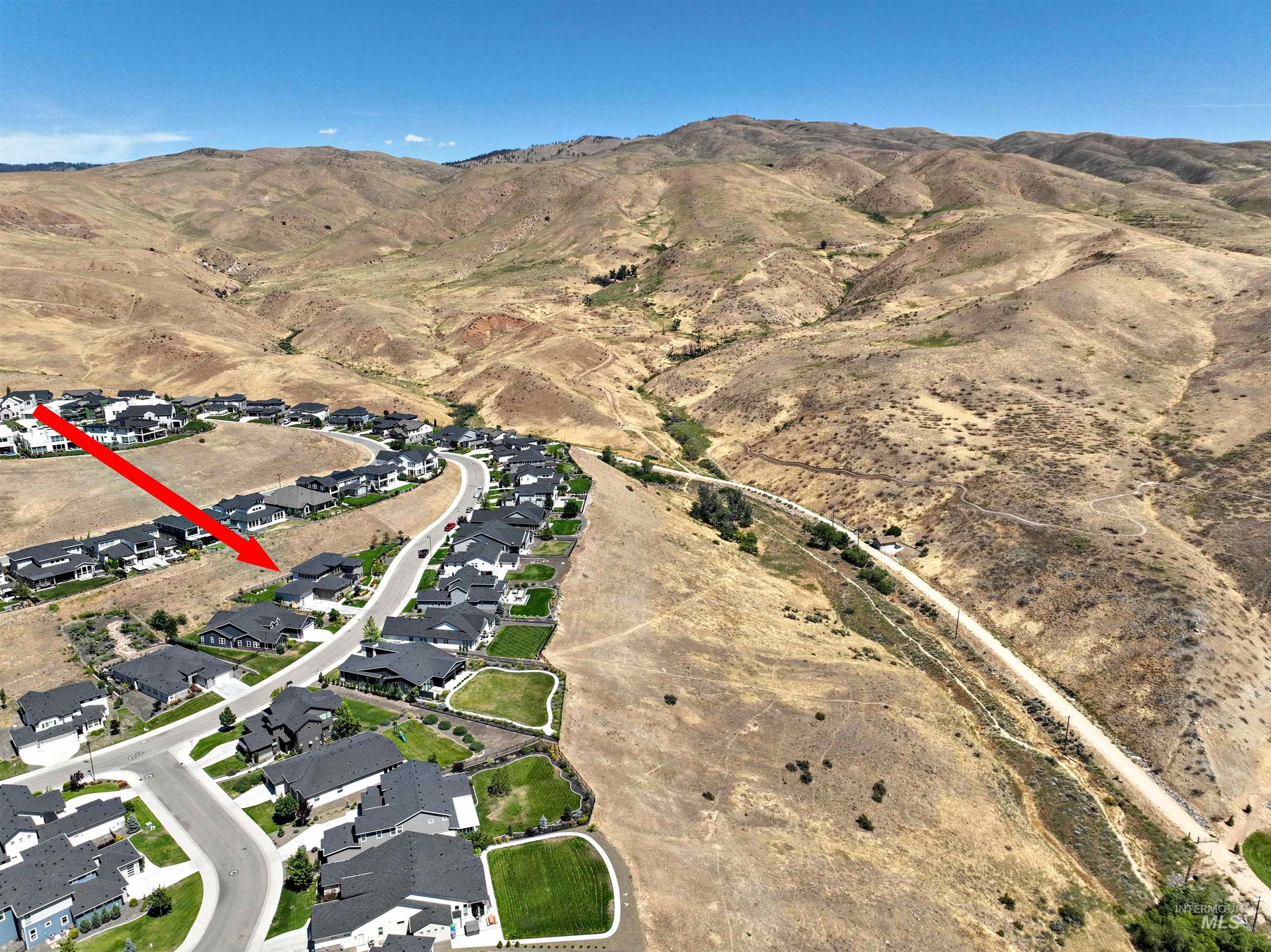 View of property location featuring a mountainous background and nearby suburban area