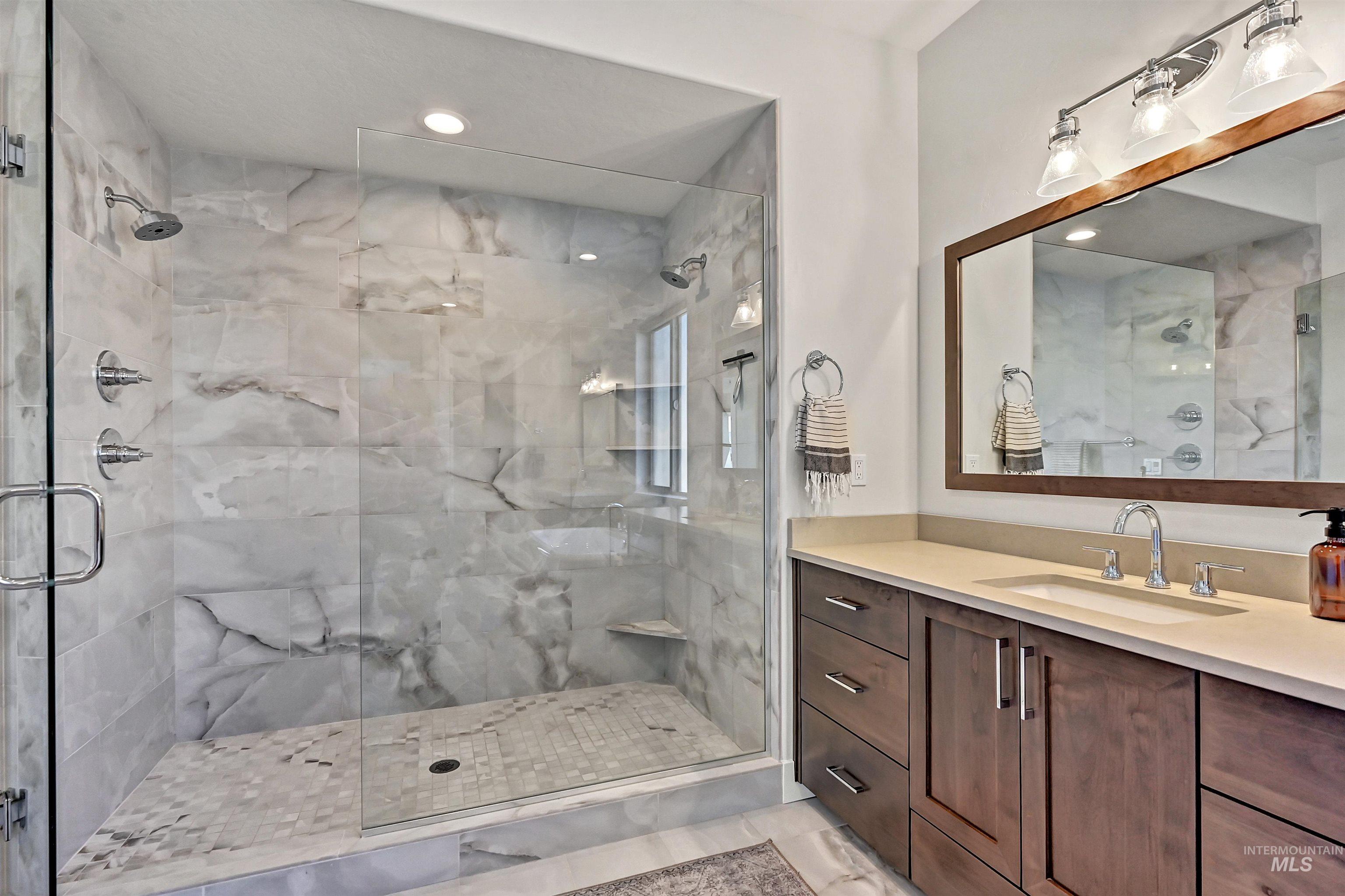 Full bath with vanity, a stall shower, and recessed lighting