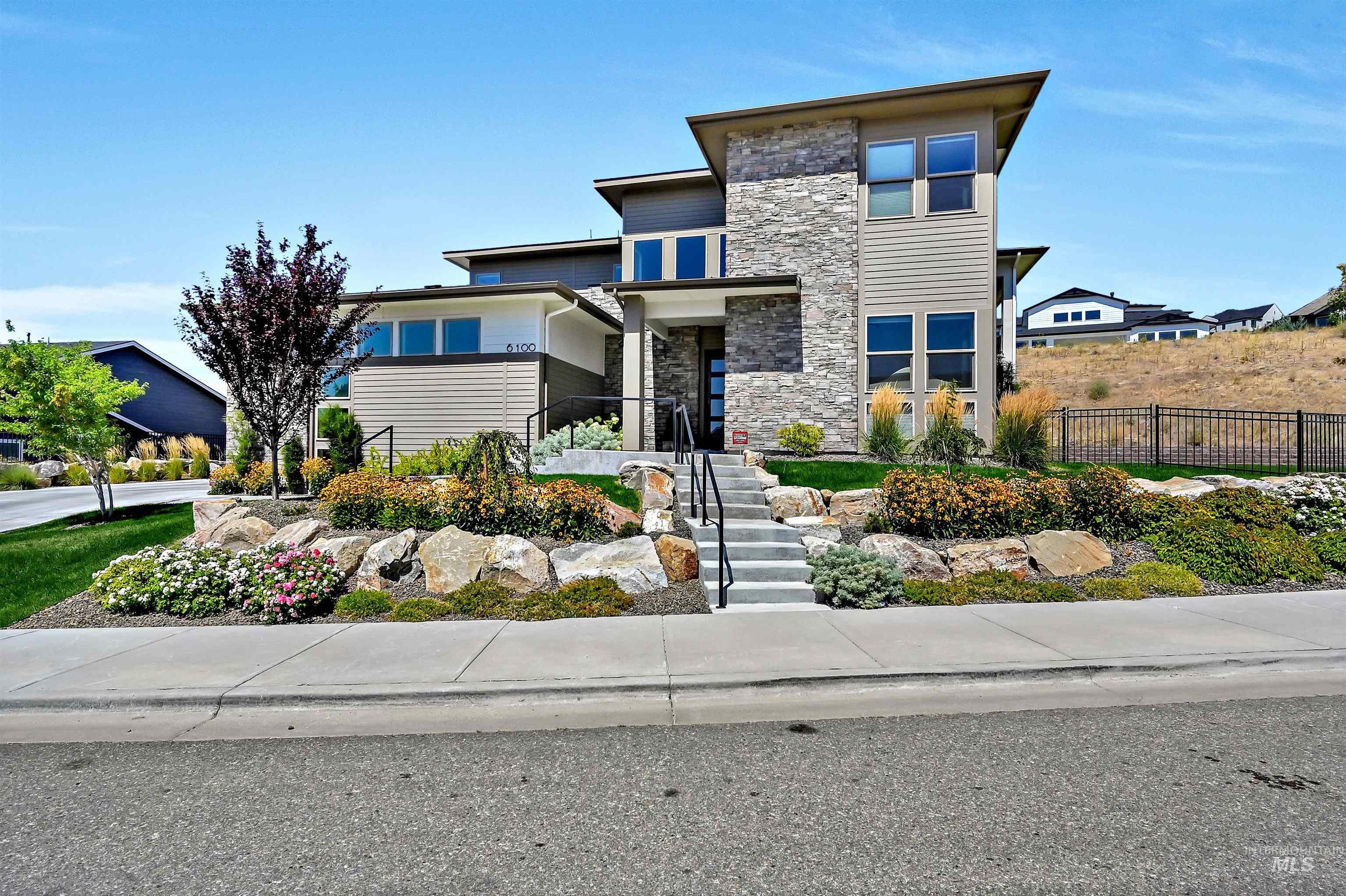 View of front of home featuring stone siding and stairway