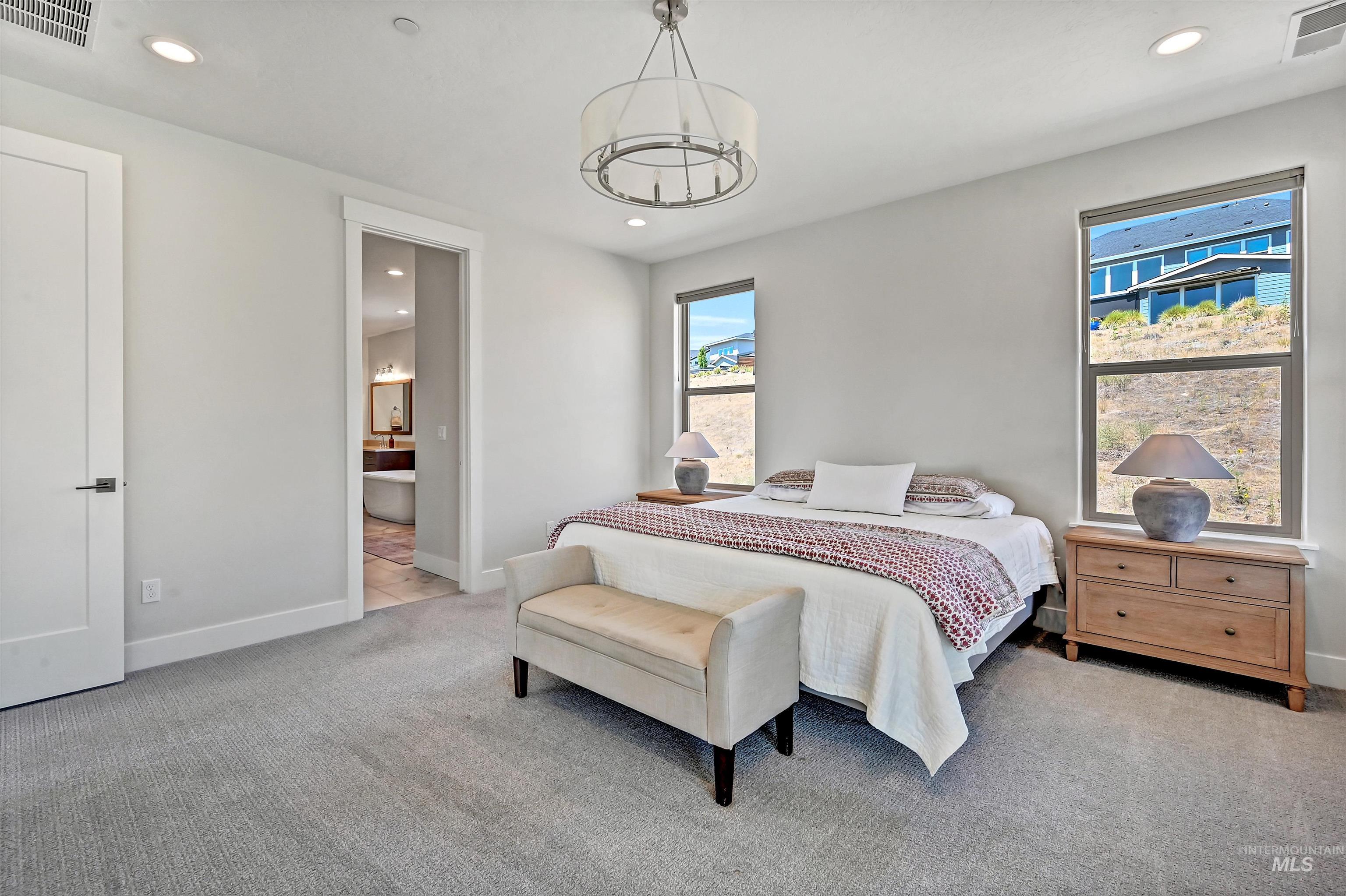 Bedroom featuring recessed lighting, light carpet, and connected bathroom