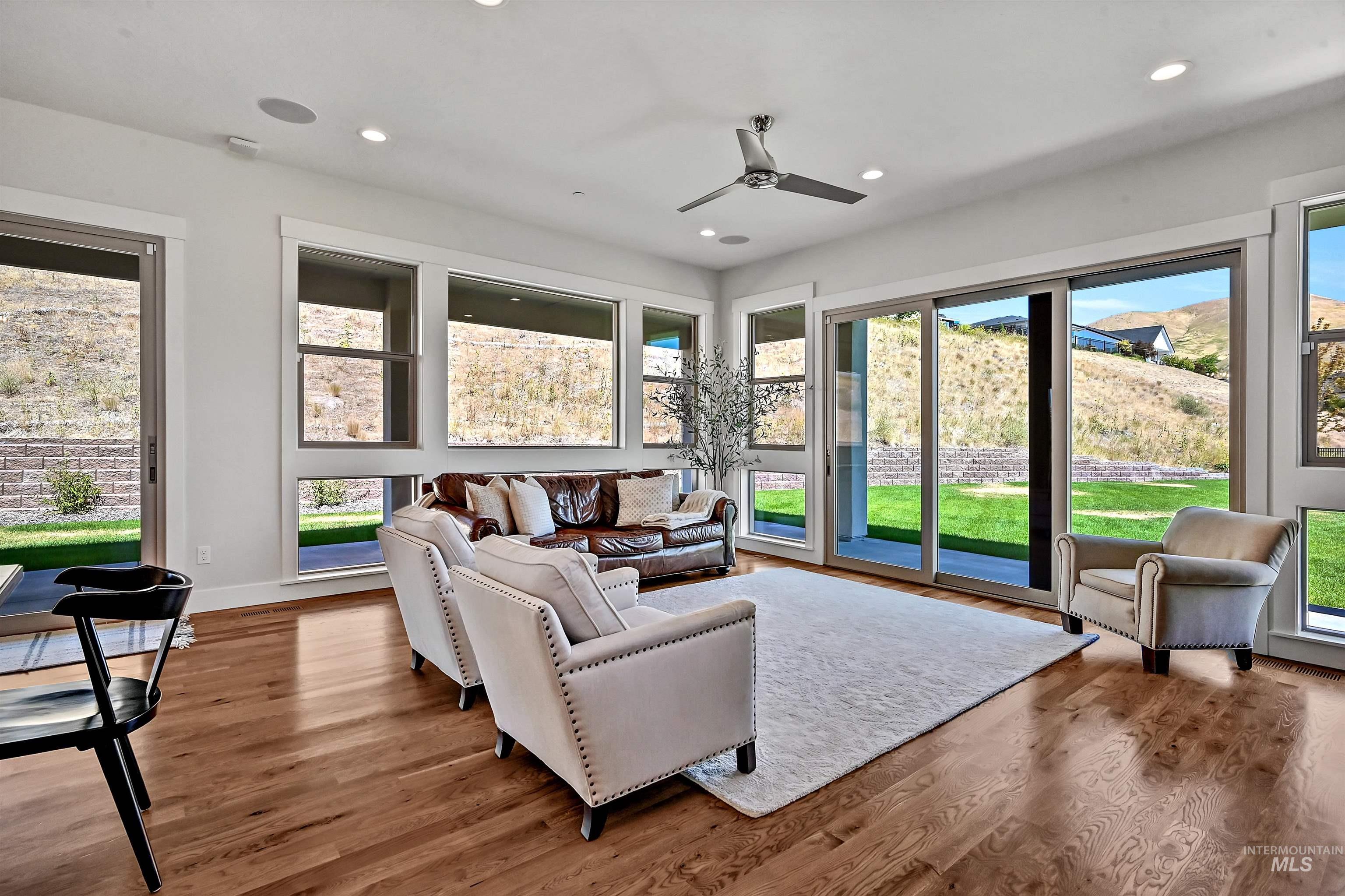 Living area with wood finished floors, recessed lighting, and ceiling fan
