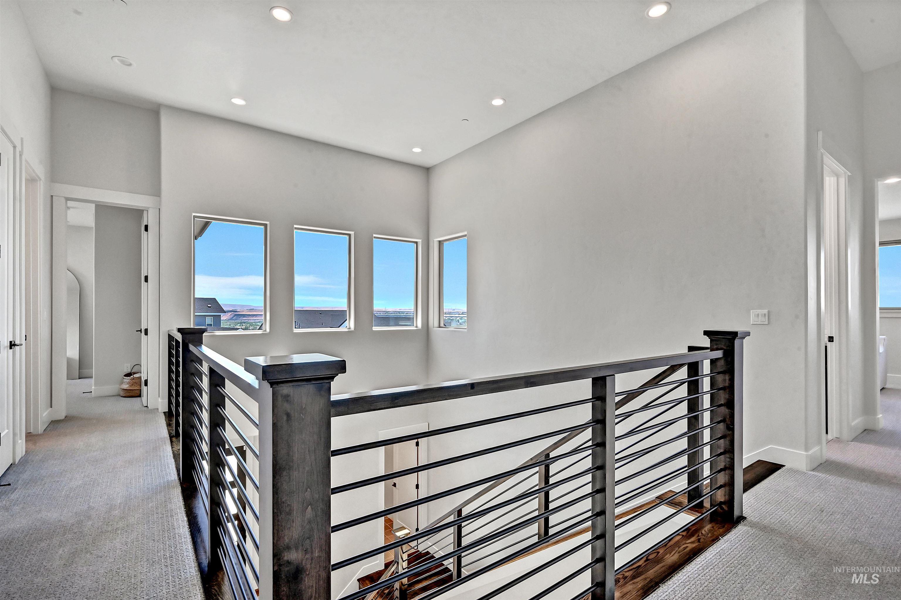Hall featuring light carpet, an upstairs landing, and recessed lighting