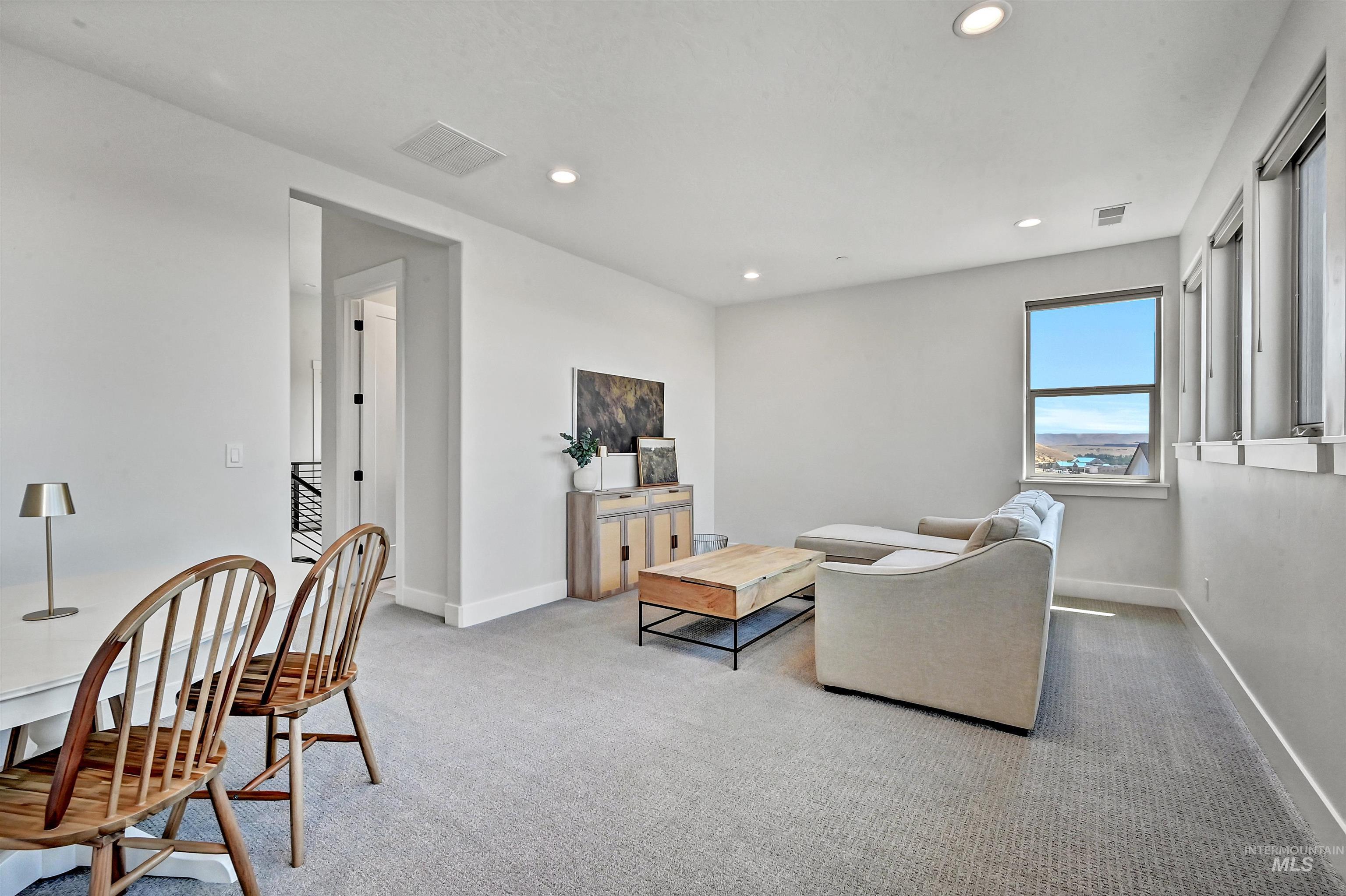 Living room featuring light carpet and recessed lighting
