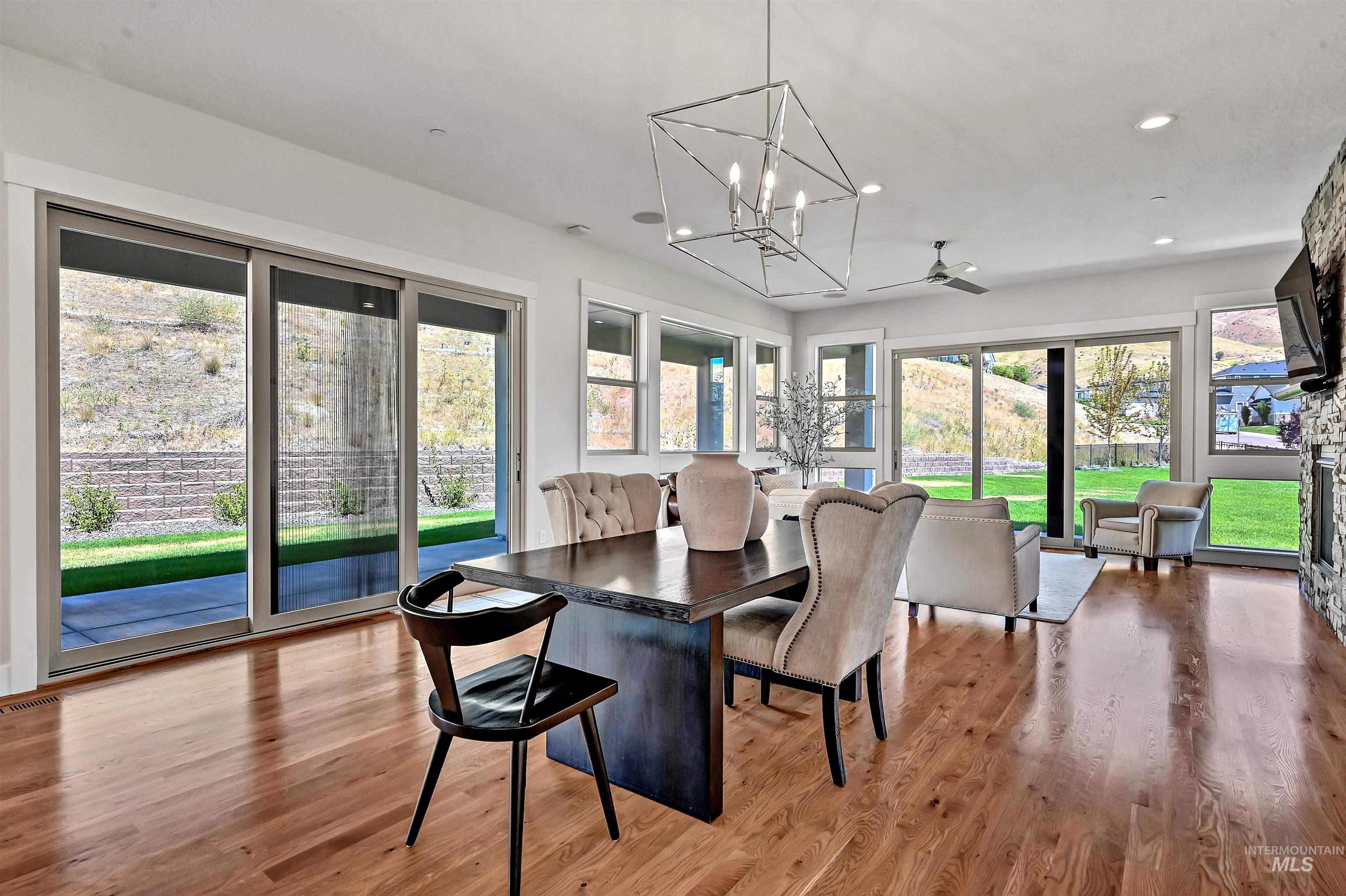 Dining space with light wood-style flooring, a chandelier, recessed lighting, and ceiling fan