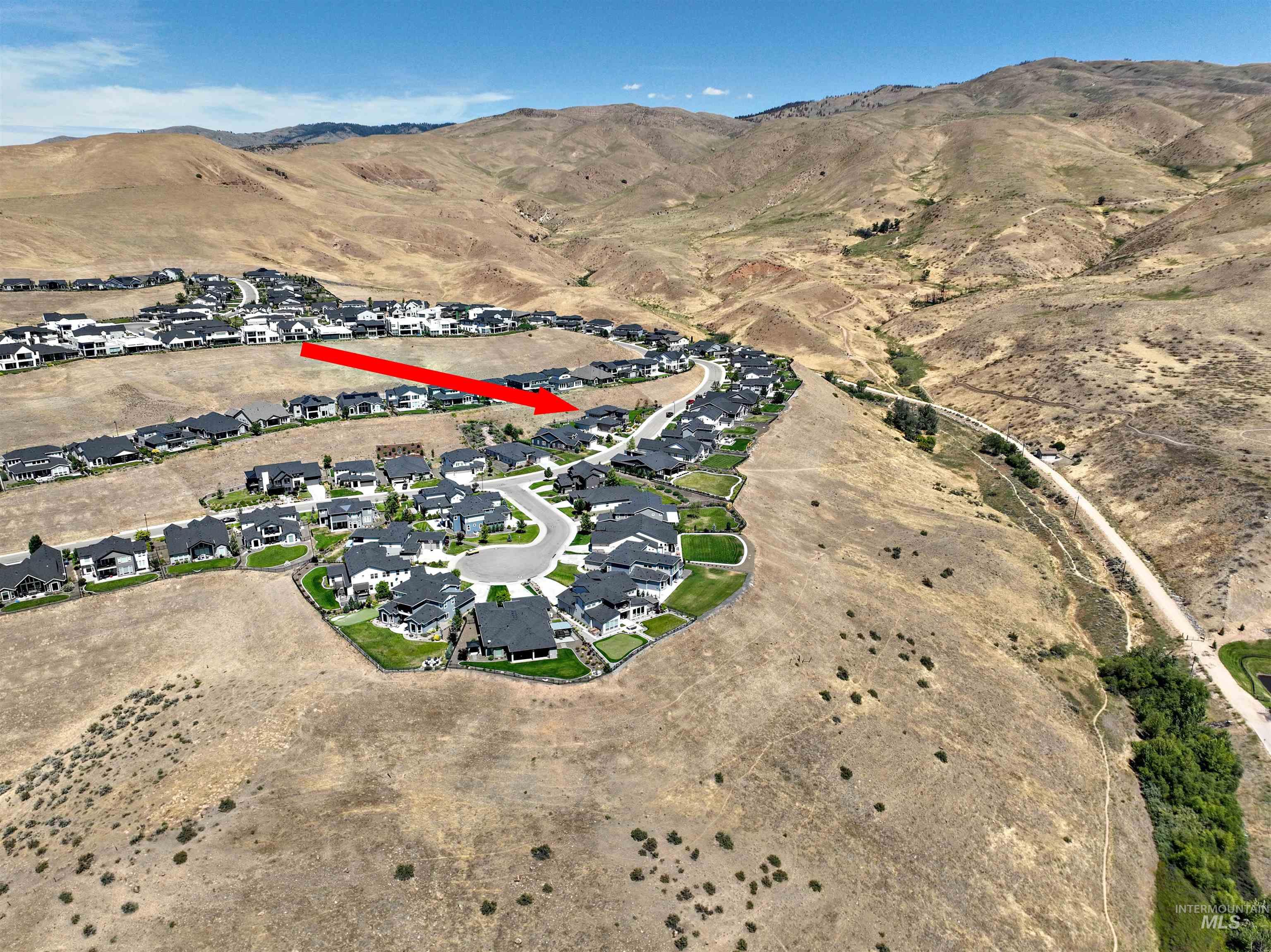 View of property location with a mountain backdrop and nearby suburban area