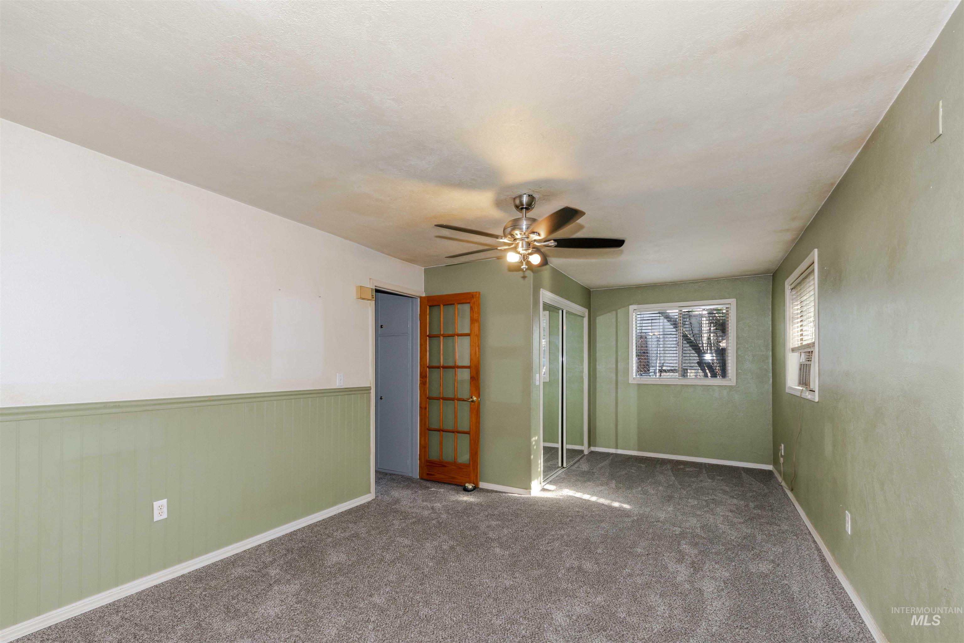 Lrg bedroom featuring new carpet and ceiling fan