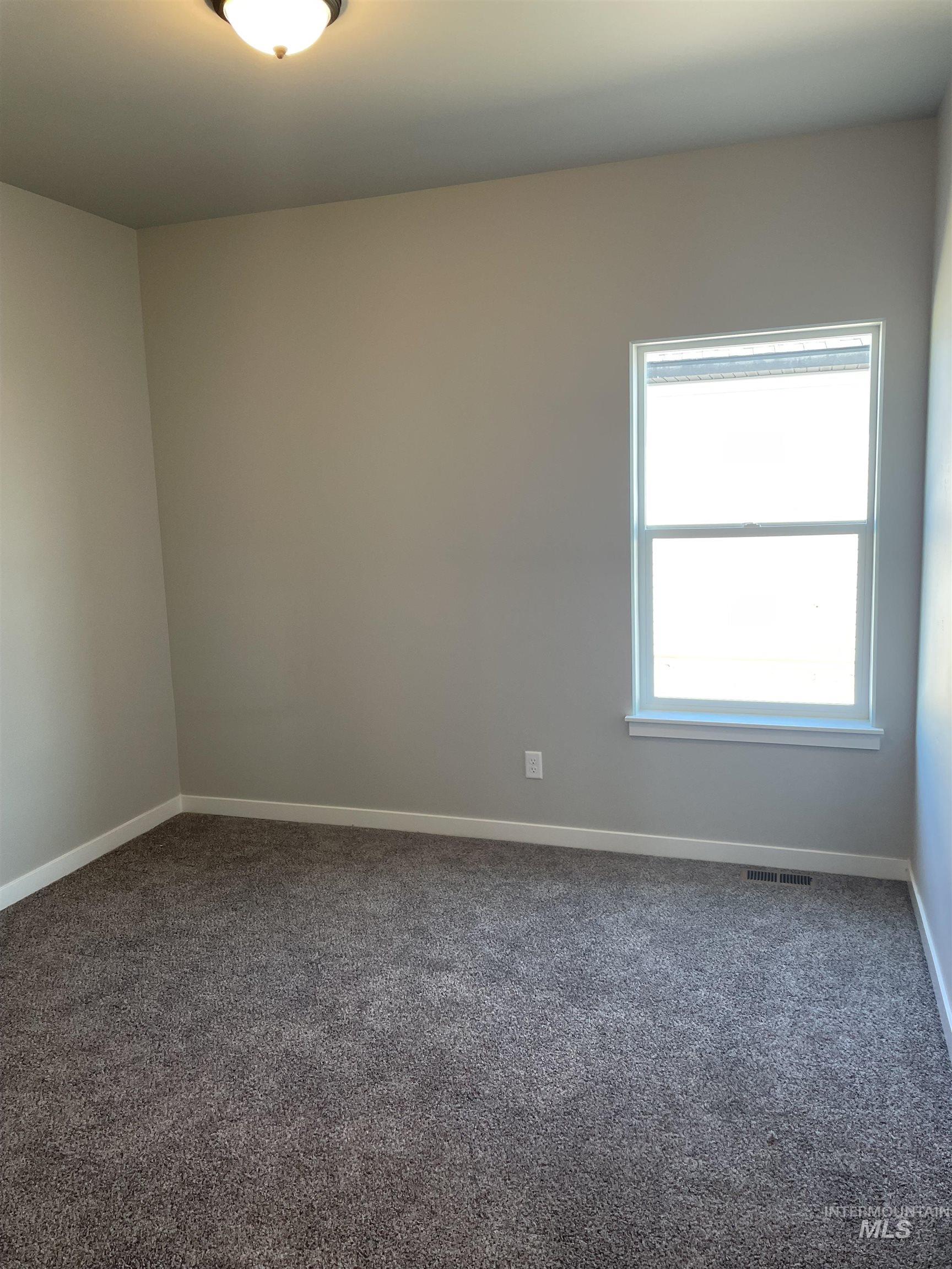 Spare room with dark carpet