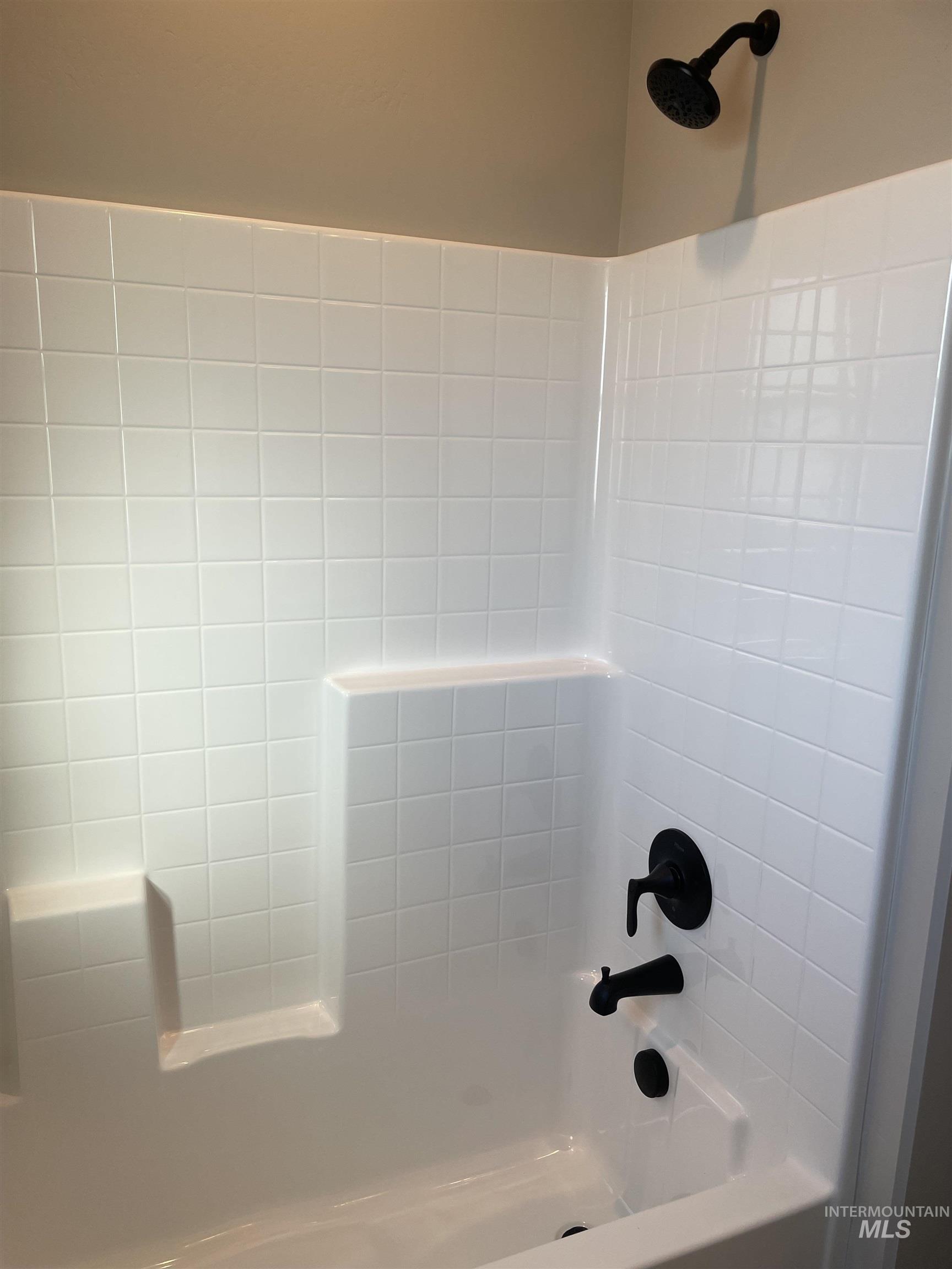 Full bath featuring shower / tub combination