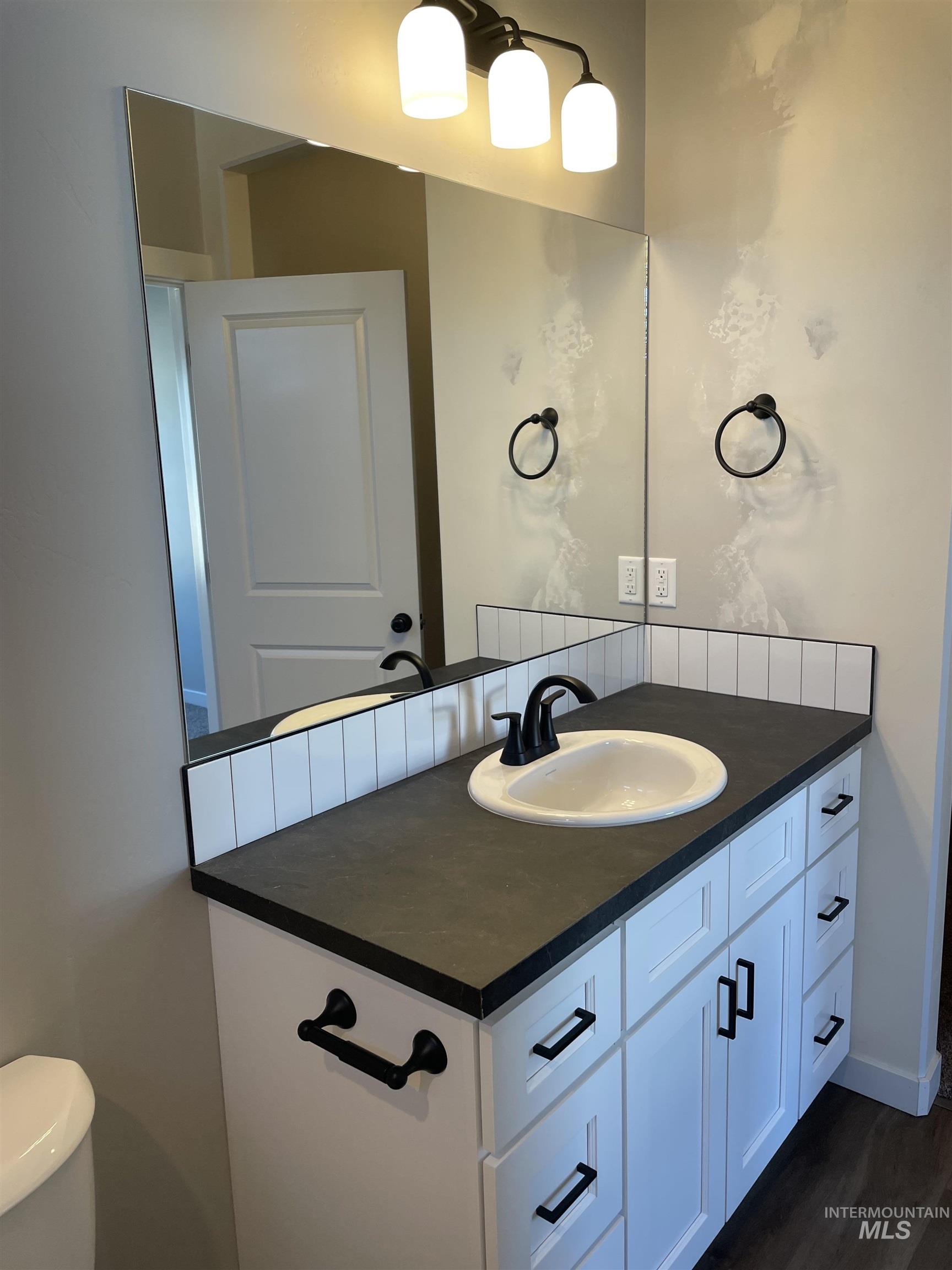 Bathroom with vanity and dark wood finished floors