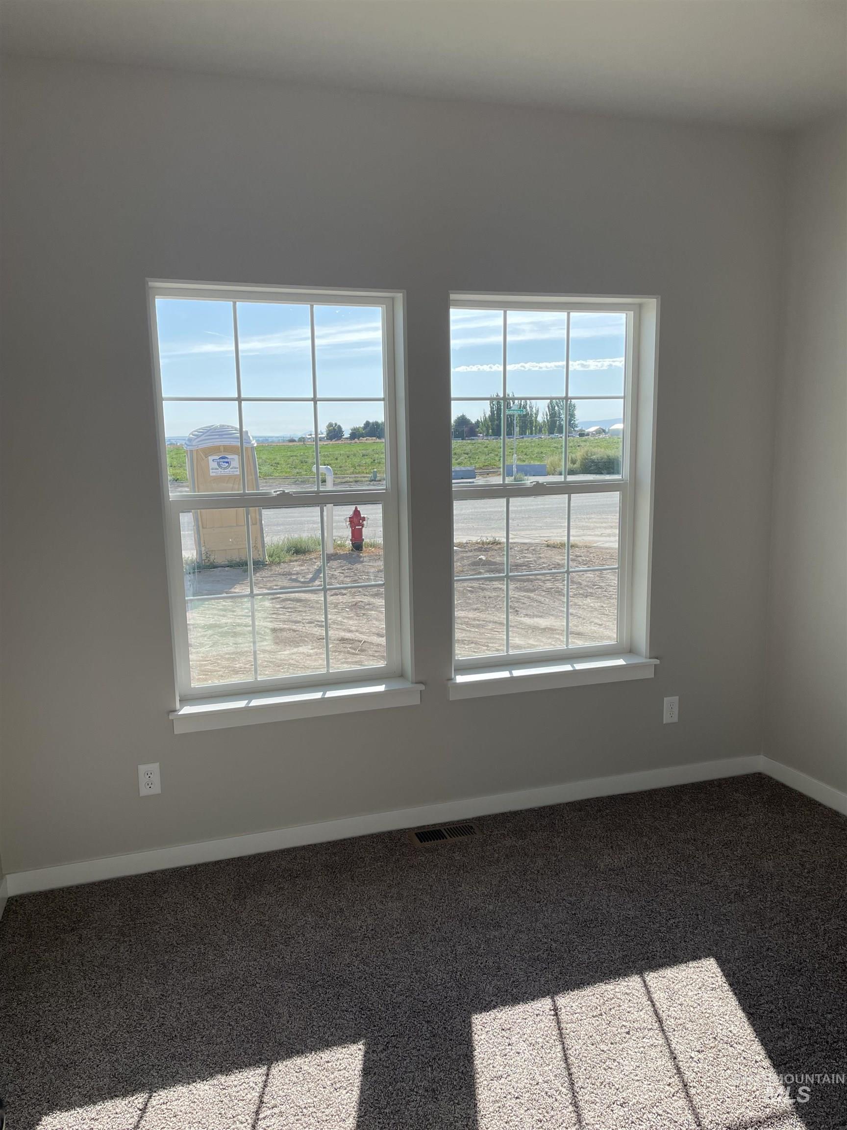 Unfurnished room with baseboards and carpet flooring