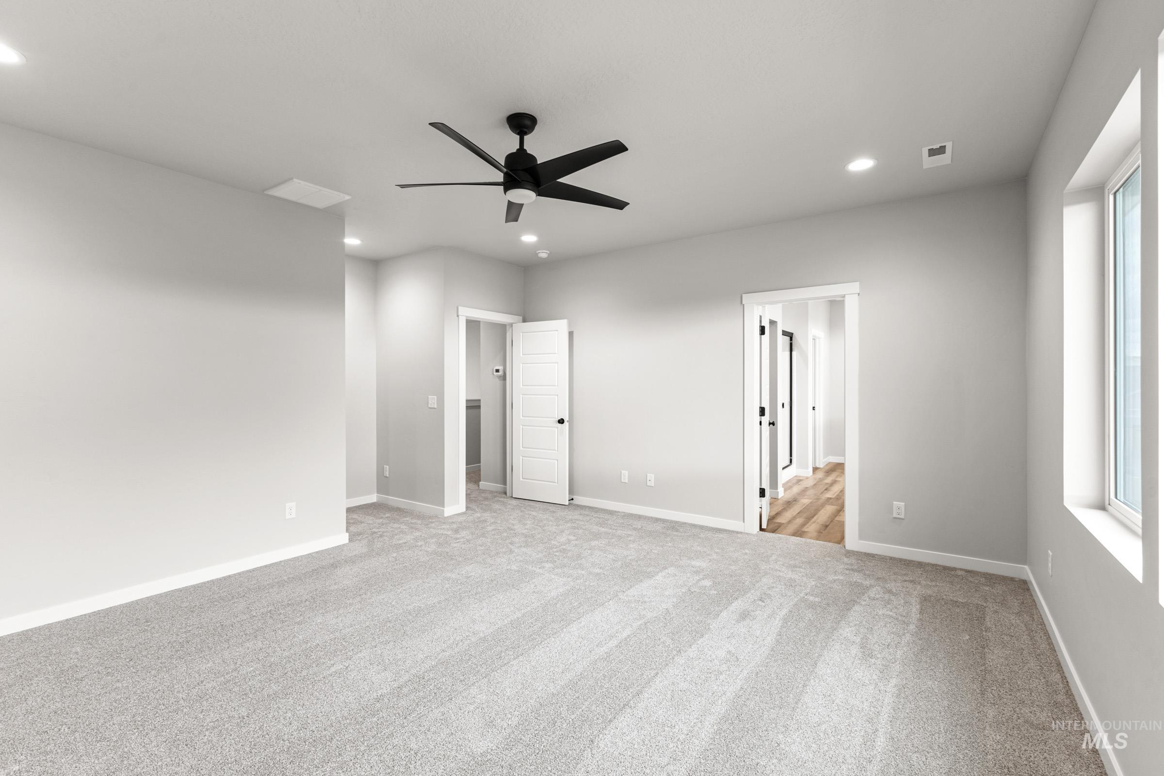 Unfurnished bedroom with a ceiling fan, light carpet, and recessed lighting