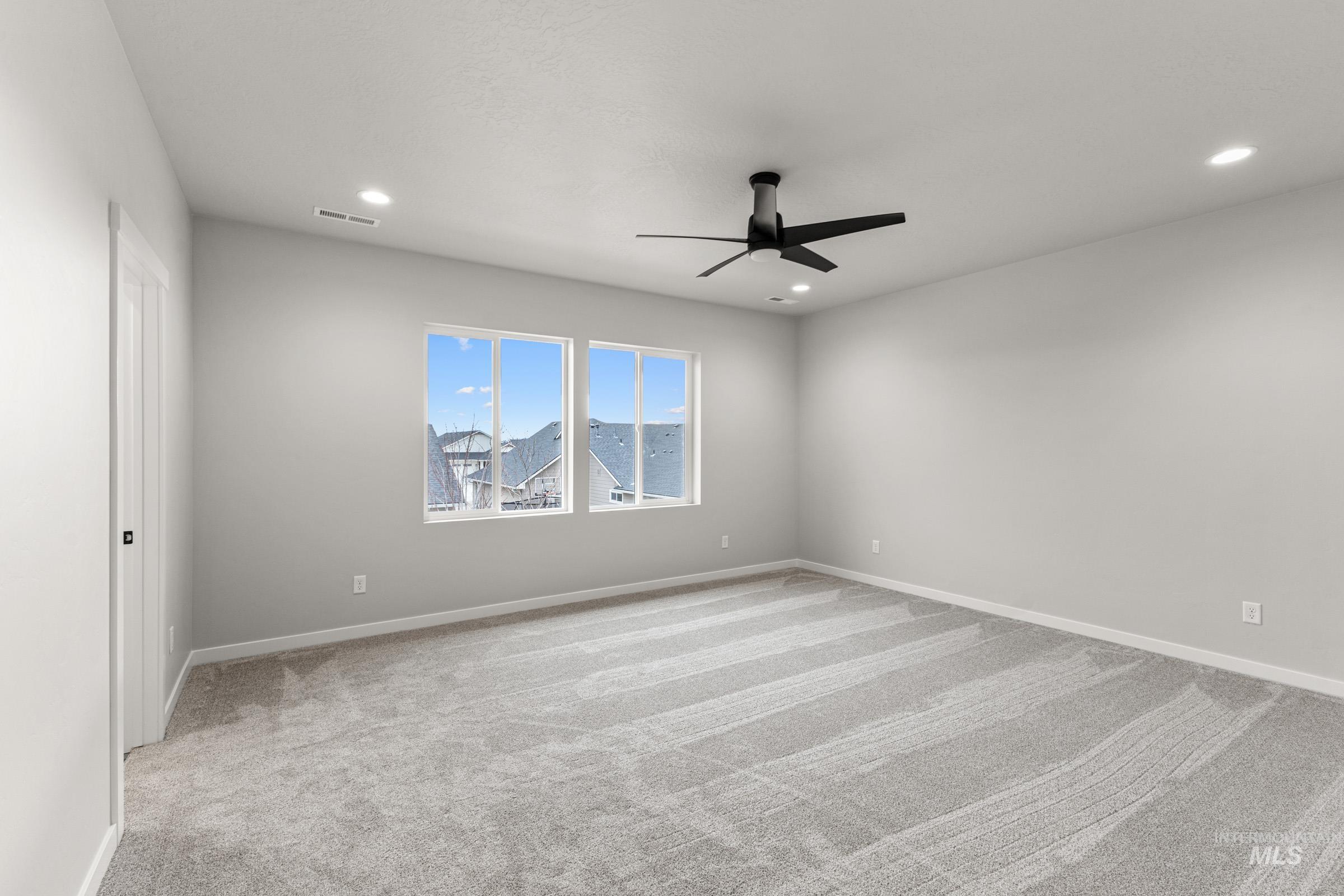 Spare room with light colored carpet, a ceiling fan, and recessed lighting