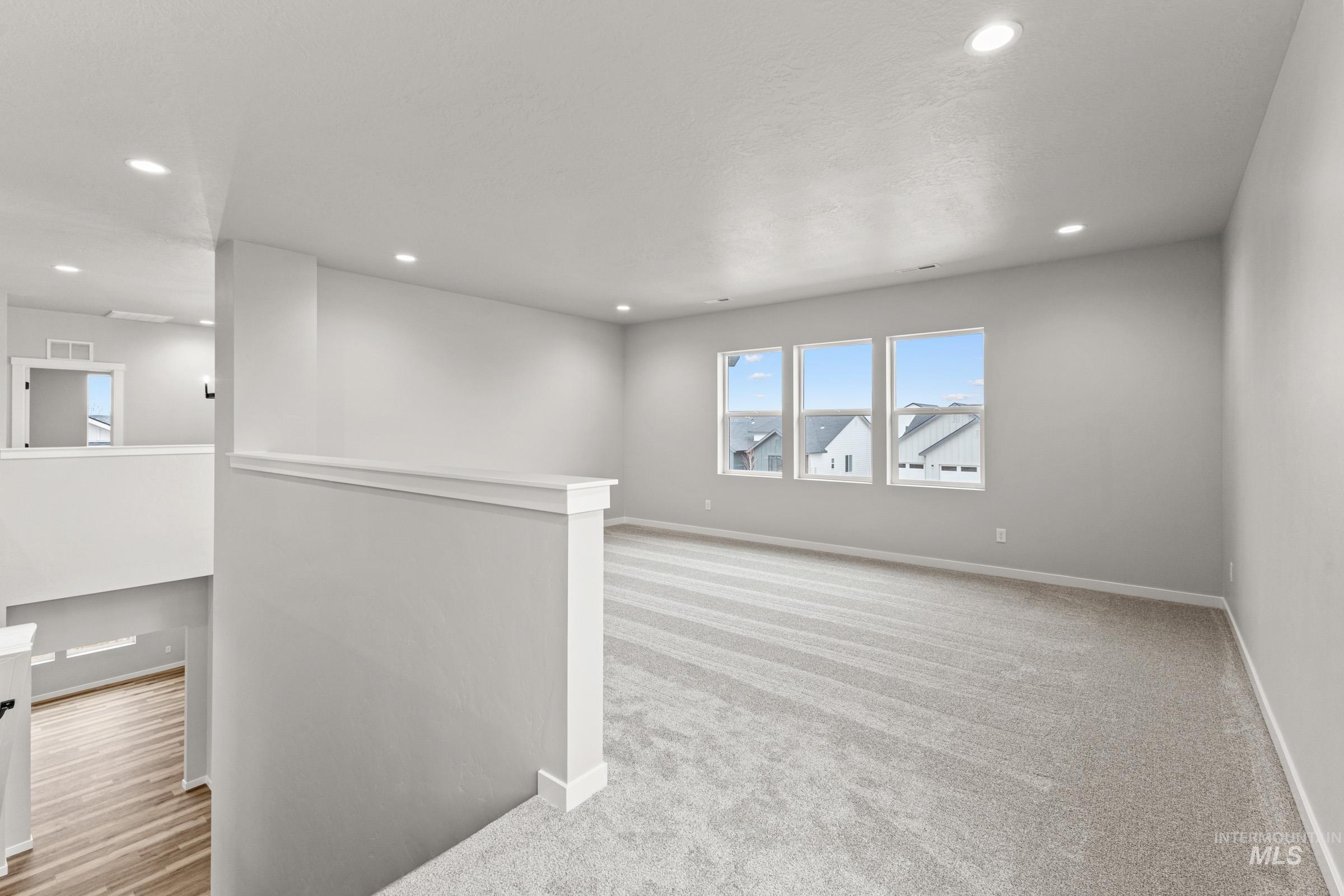 Unfurnished room featuring light colored carpet and recessed lighting
