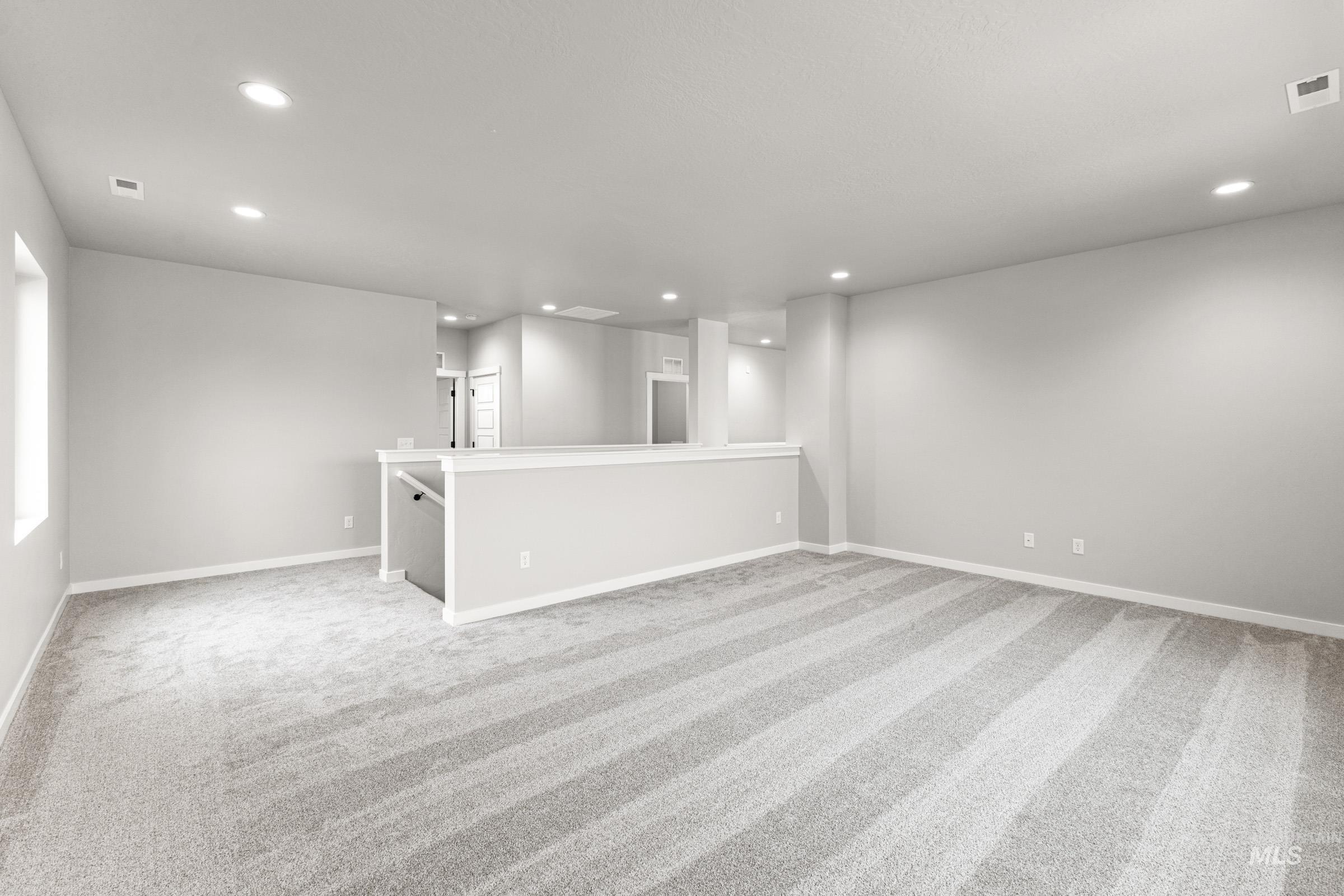 Unfurnished room with light colored carpet and recessed lighting