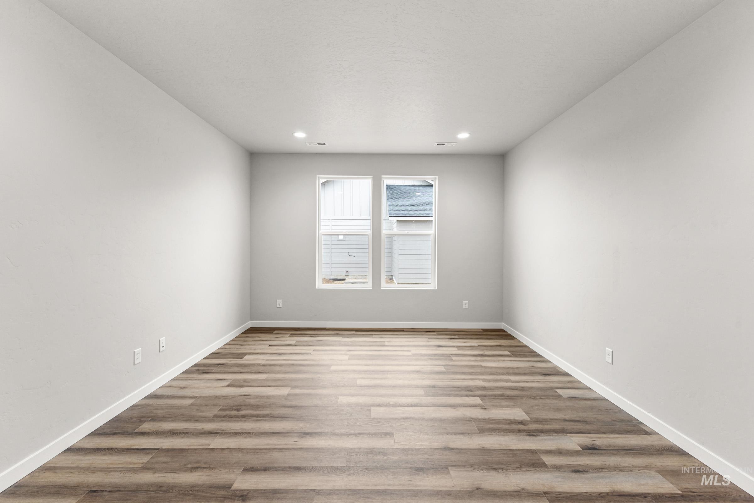 Unfurnished room with light wood finished floors and recessed lighting