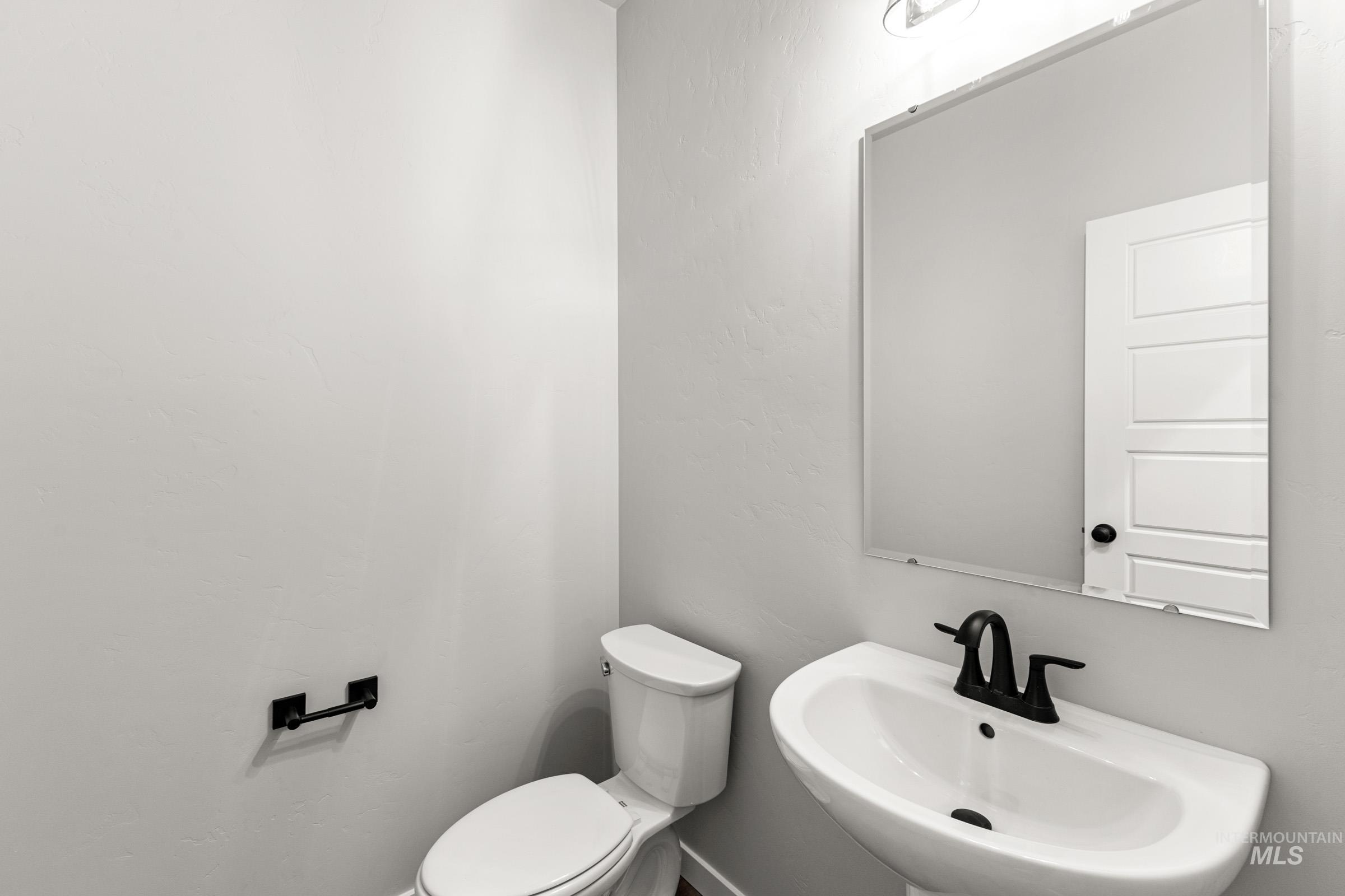 Half bathroom with a sink and toilet
