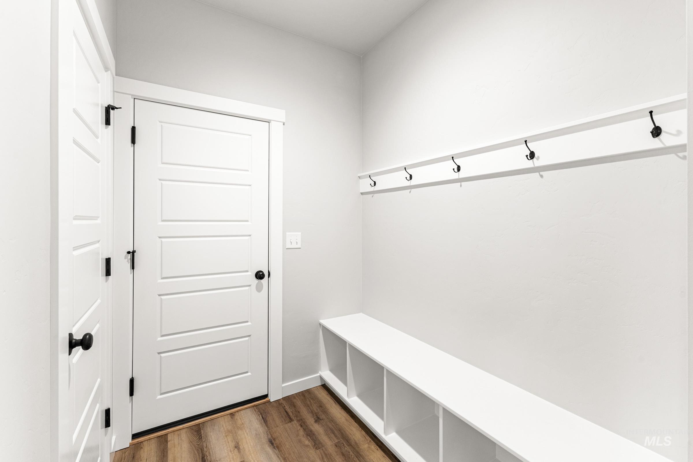 Mudroom with dark wood finished floors