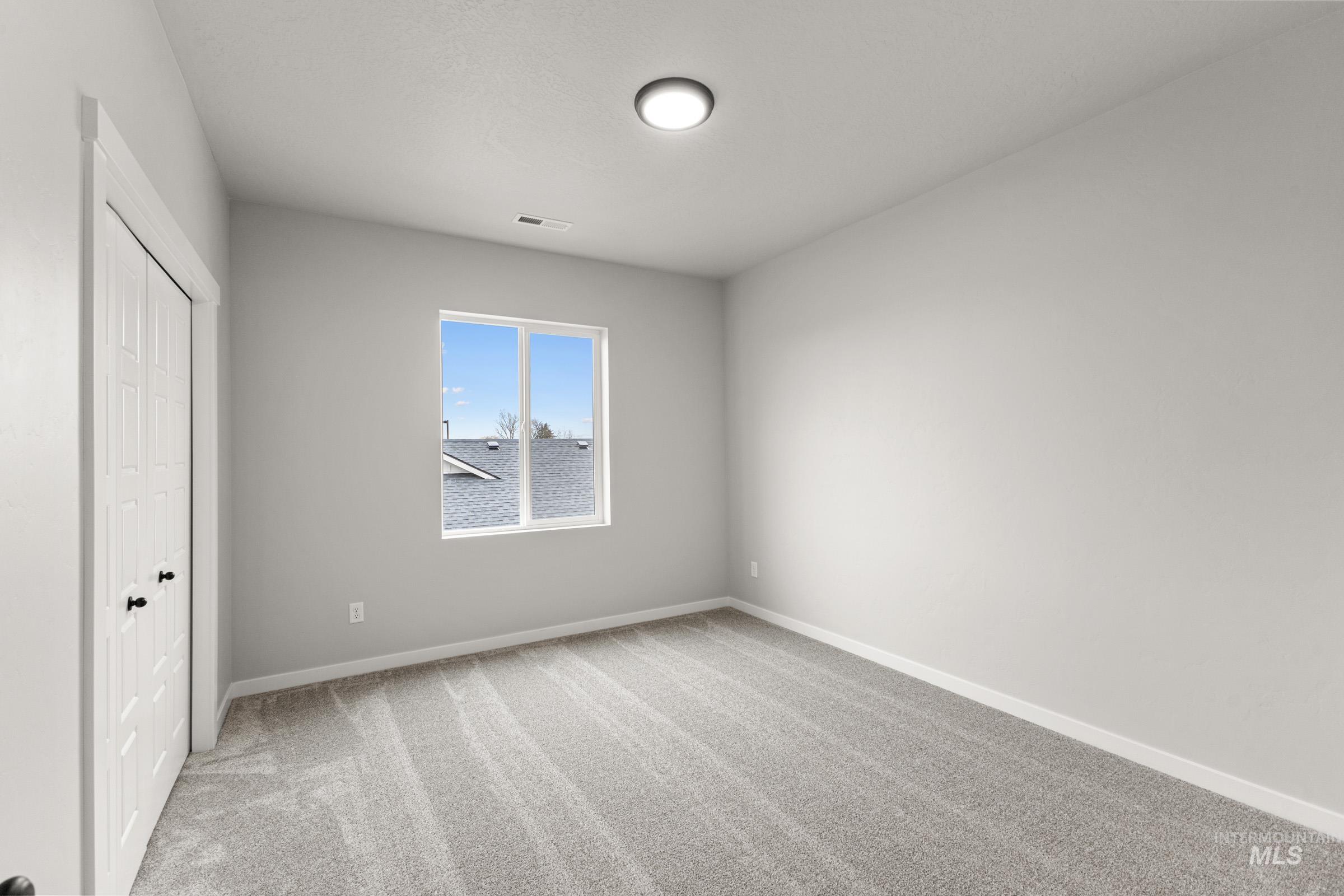 Unfurnished bedroom with a closet and light colored carpet