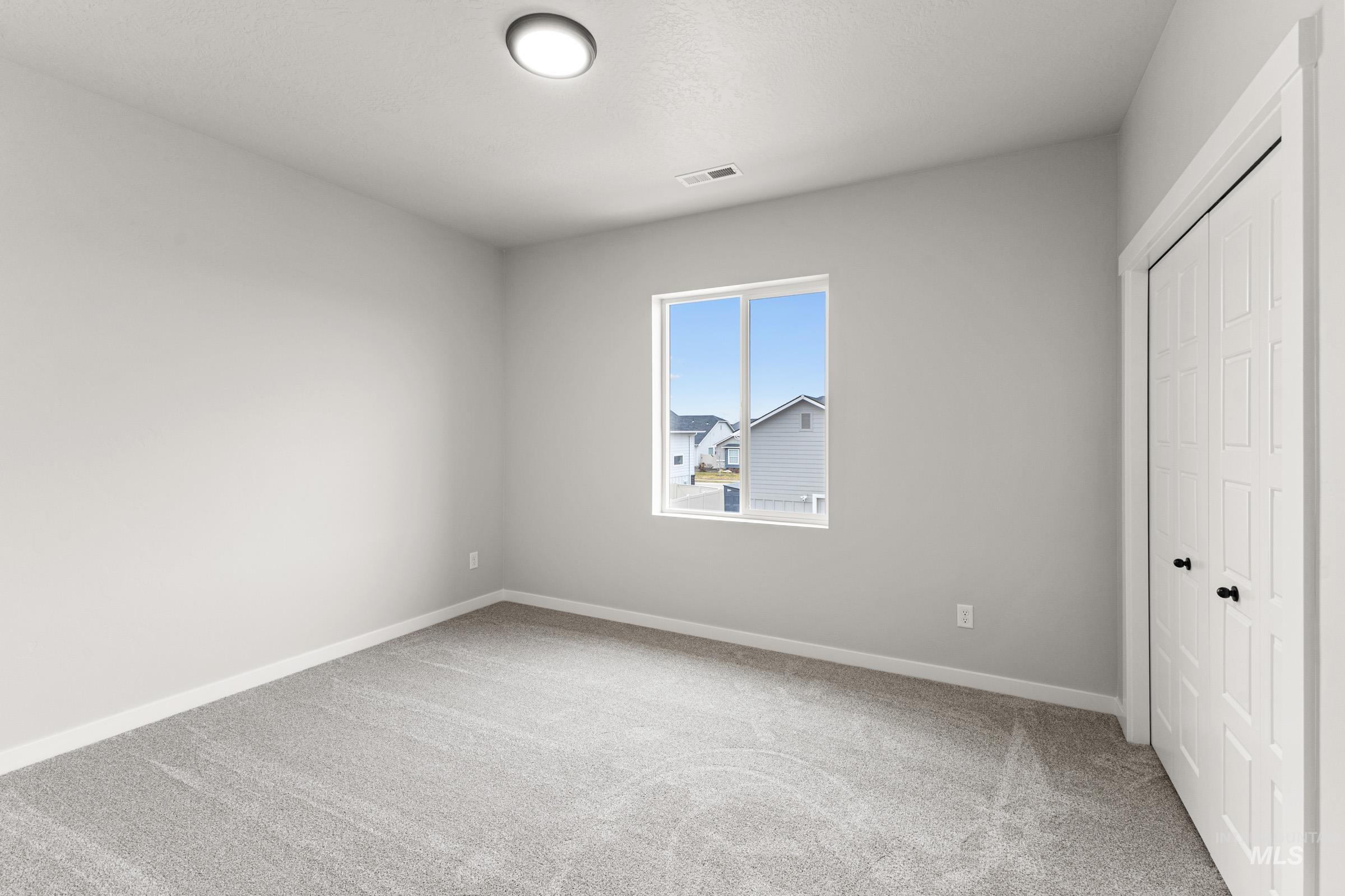 Unfurnished bedroom with a closet and light carpet