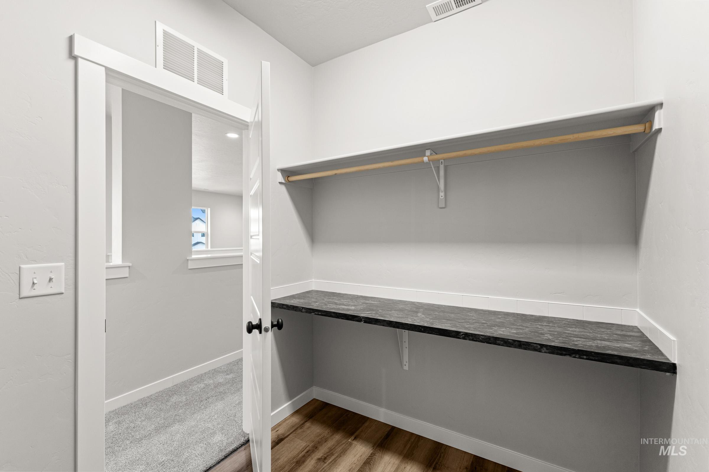 Walk in closet featuring light wood-type flooring
