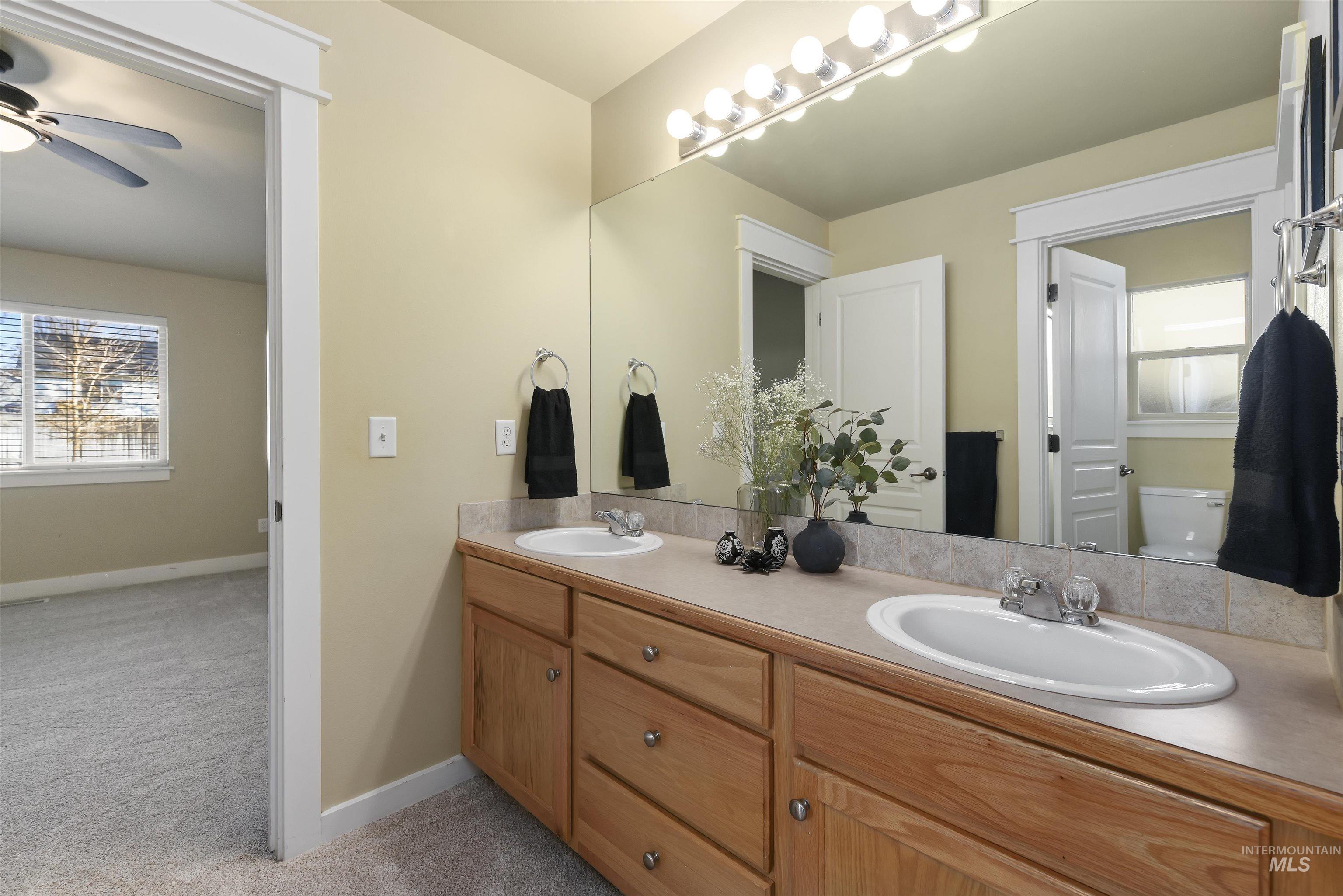 The primary bedroom ensuite offers a bathroom dual vanities and separate room for commode and shower/tub combo.
