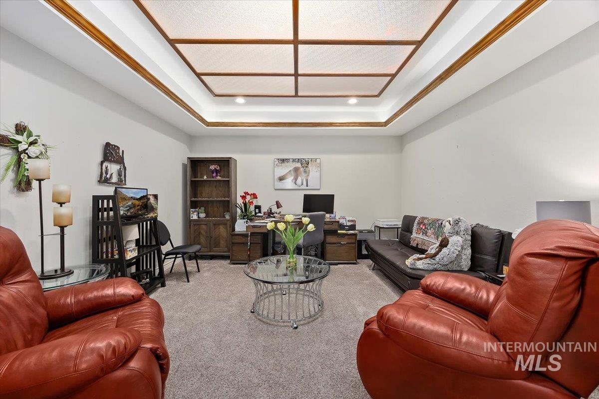 Carpeted living area with an office area