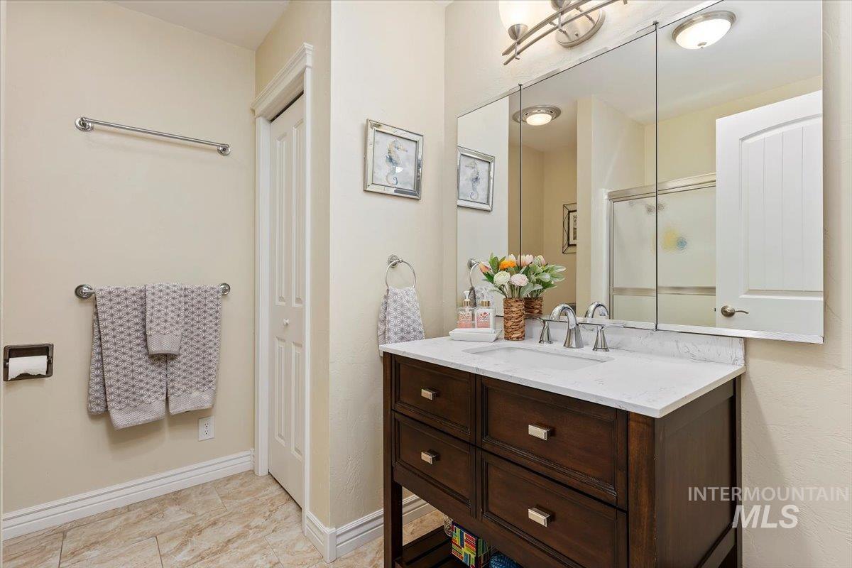 Full bath featuring a closet and vanity