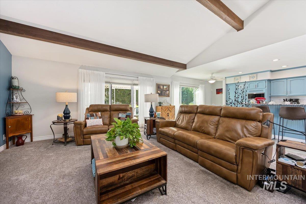 Living area with vaulted ceiling with beams, carpet floors, a ceiling fan, and recessed lighting