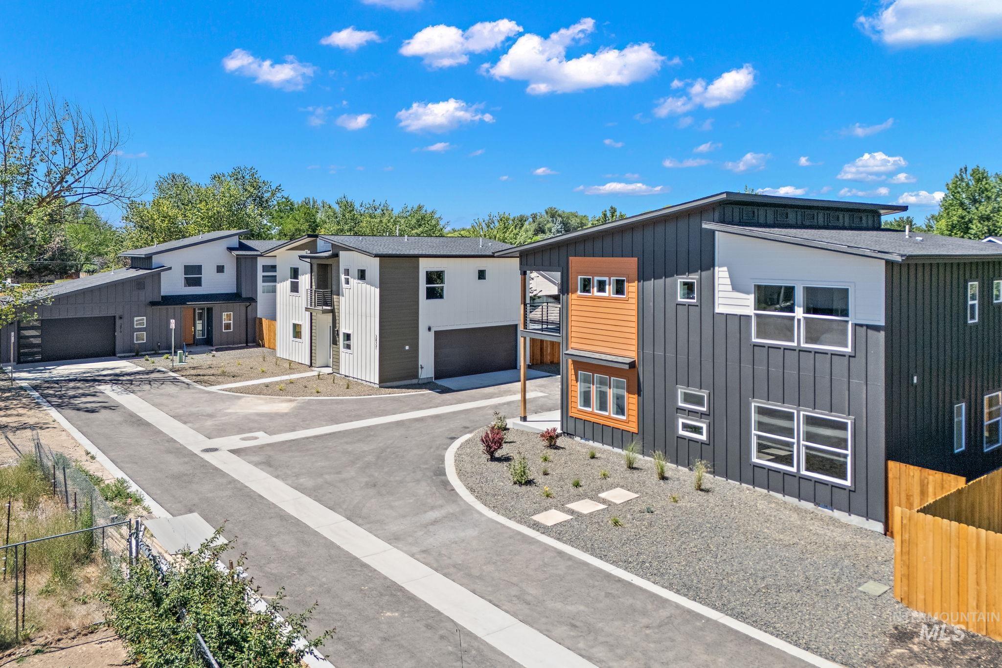 View of front facade featuring board and batten siding and a detached garage