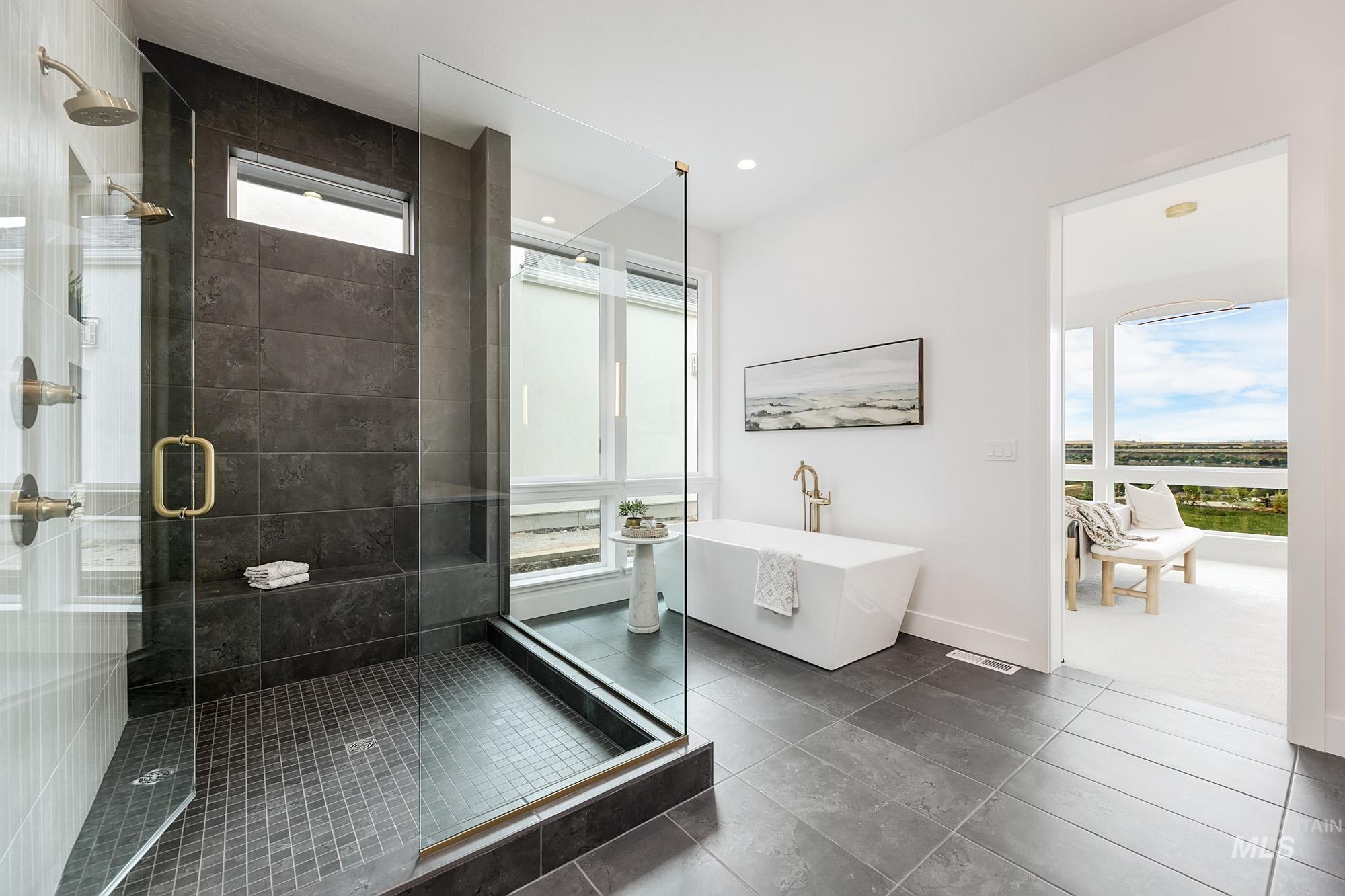 Contemporary bathroom featuring a spacious walk-in shower with dark large-format tiles and a built-in bench