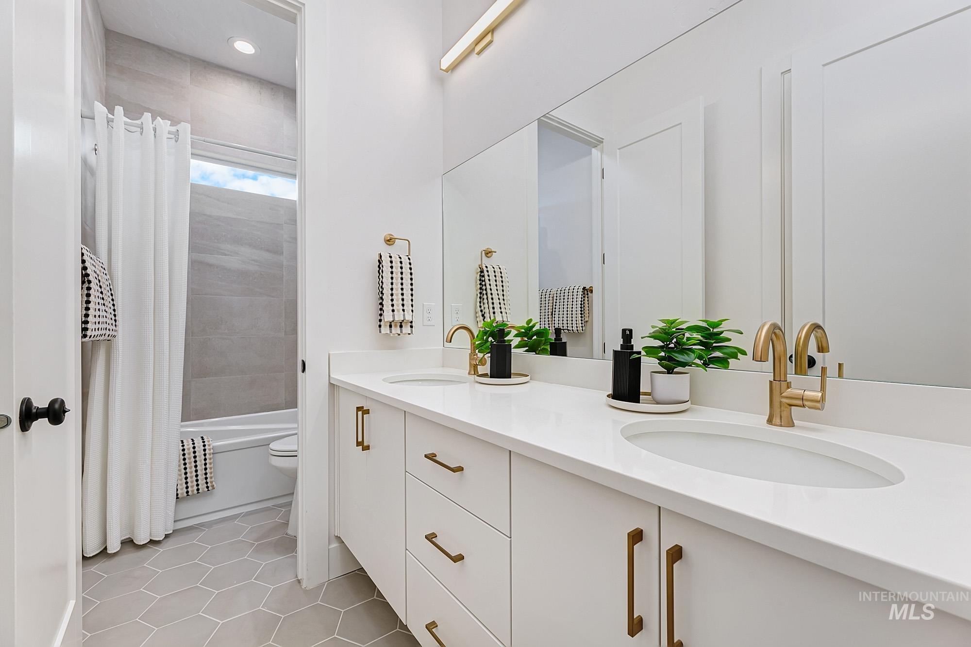 Double vanity with white cabinetry and integrated sinks