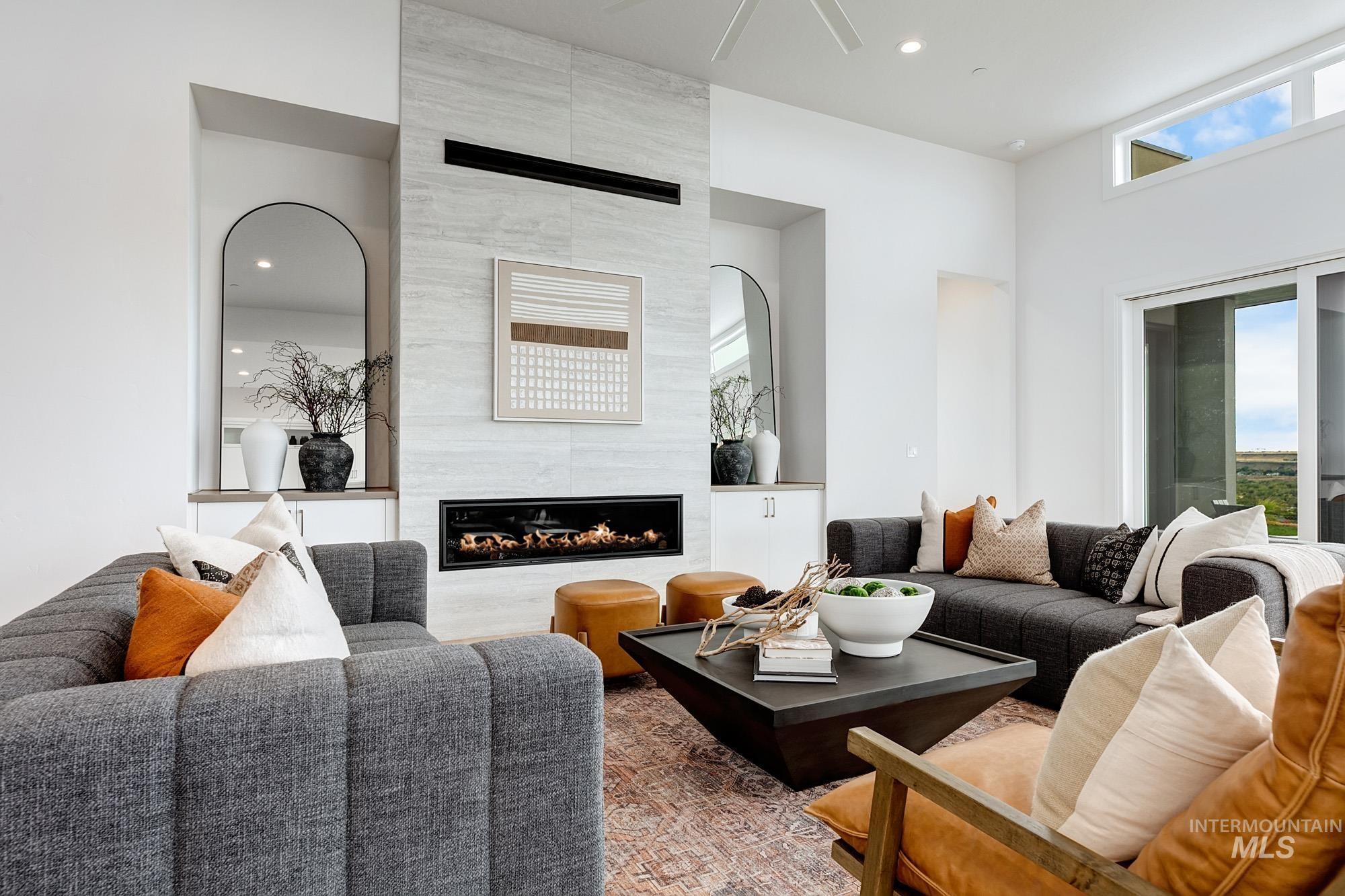 Living area featuring a floor-to-ceiling tiled fireplace surround with a linear electric fireplace