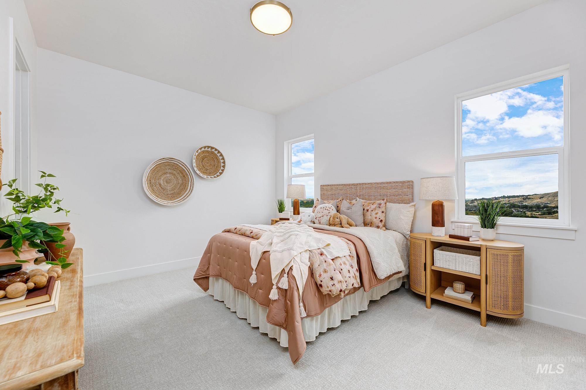 Bright bedroom with light-colored carpeting and white walls