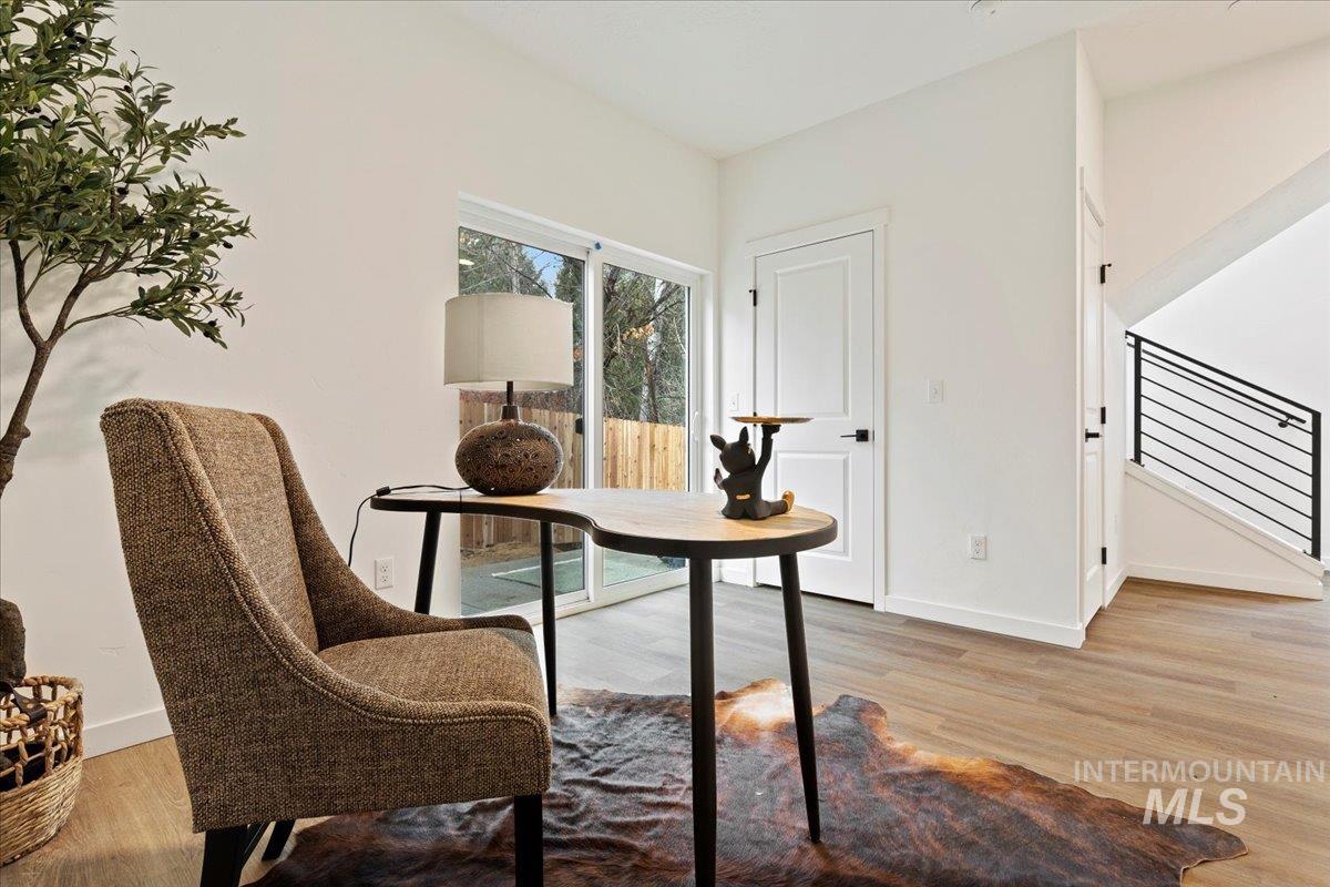 Dining space with light wood finished floors and stairway