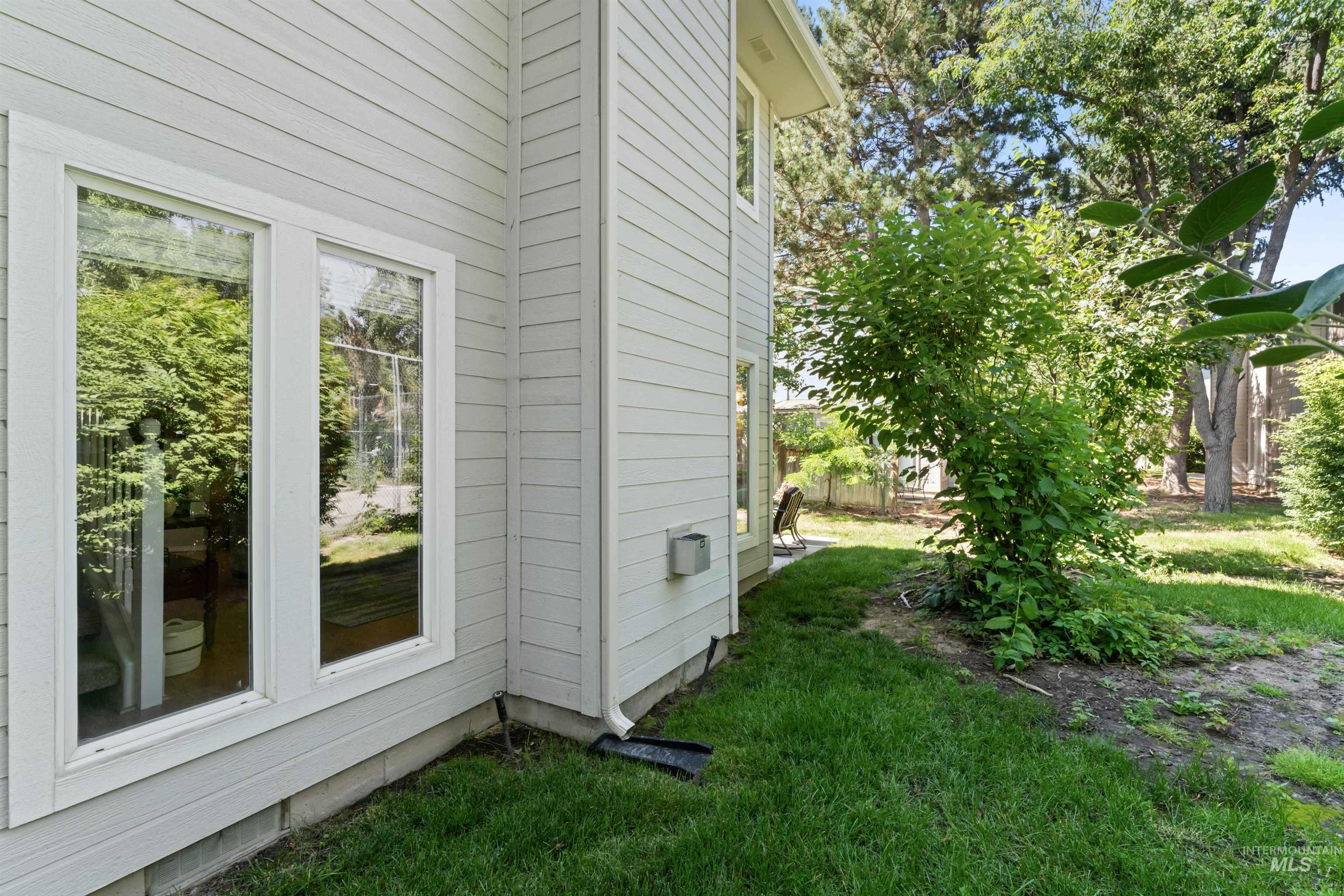 View of property exterior with a yard