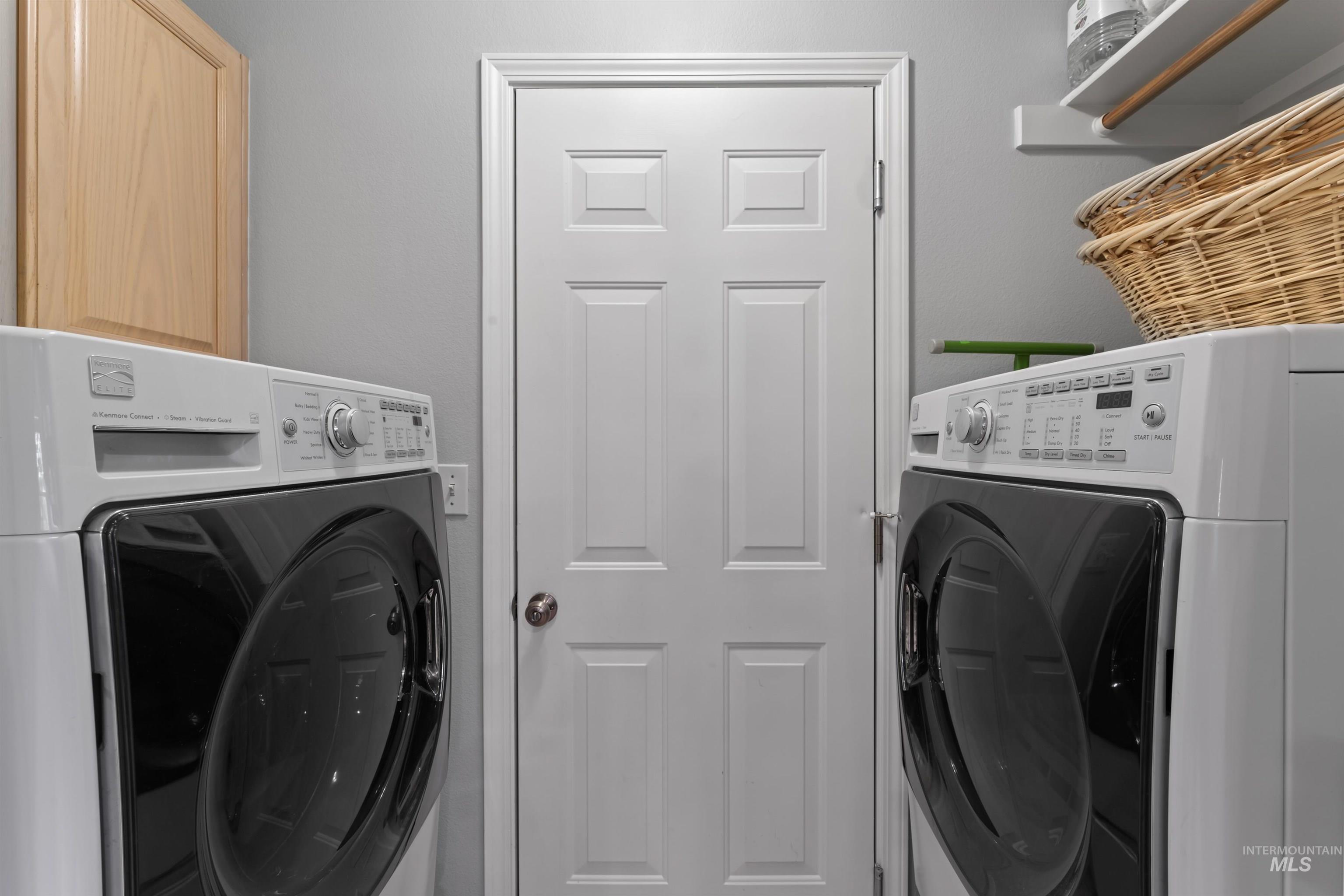 Laundry area with separate washer and dryer and cabinet space