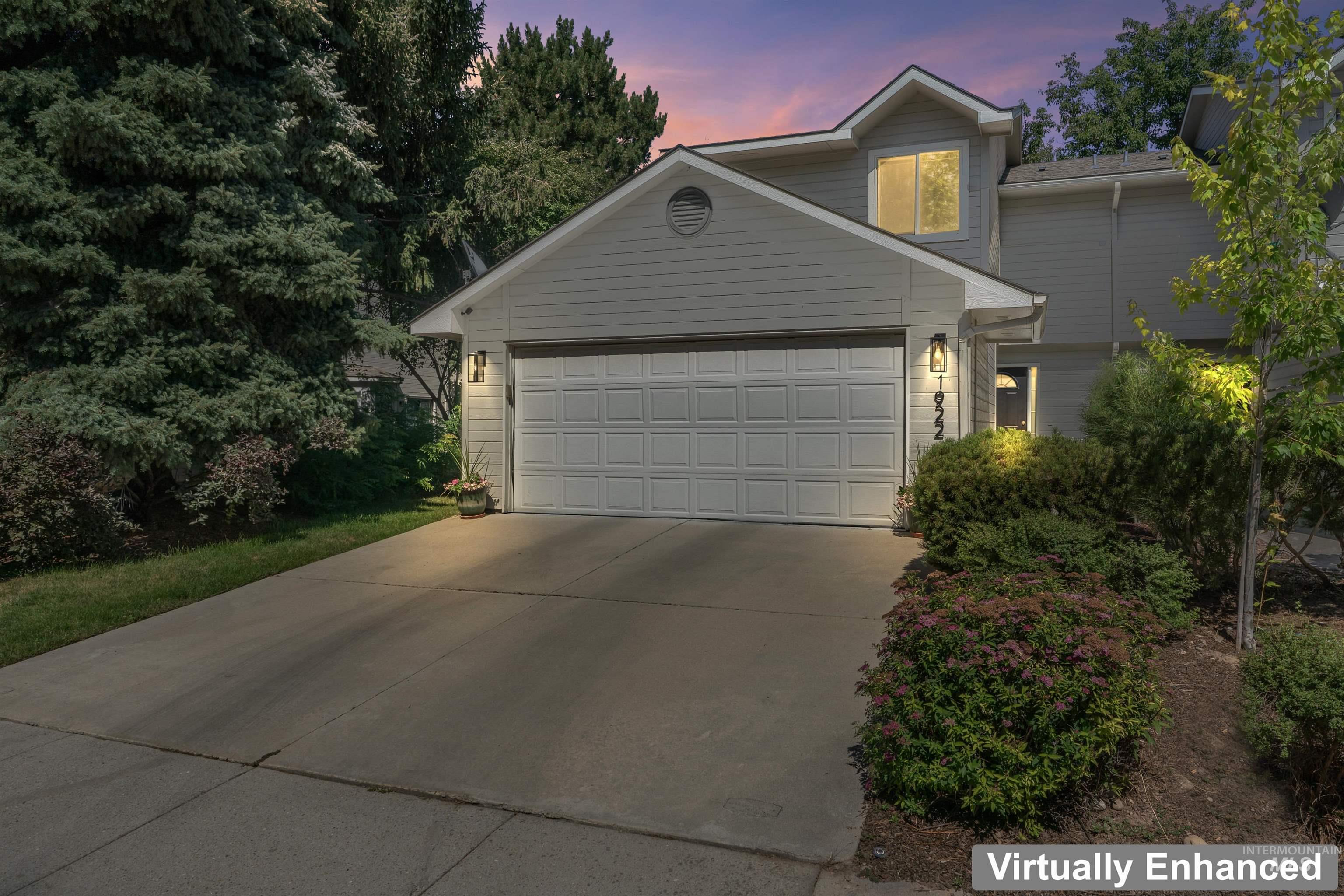 Traditional-style house with concrete driveway and a garage